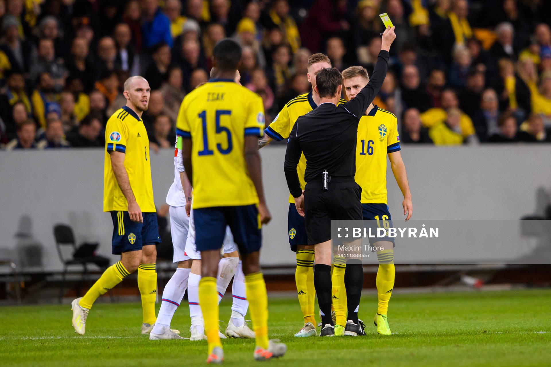 Mattias Svanberg of Sweden receives a yellow card from