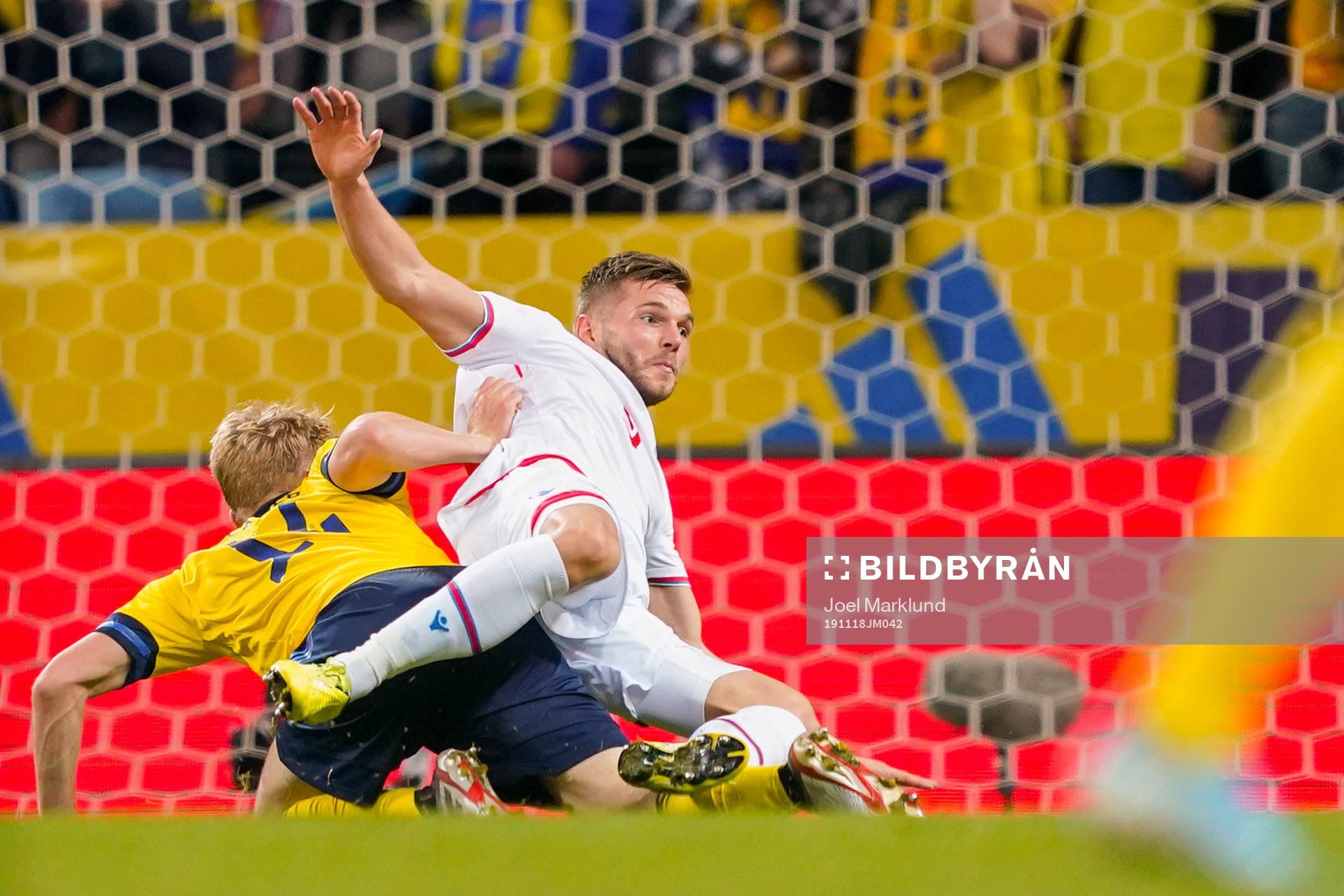 Filip Helander of Sweden tackles Gilli Rólantsson of Faroe