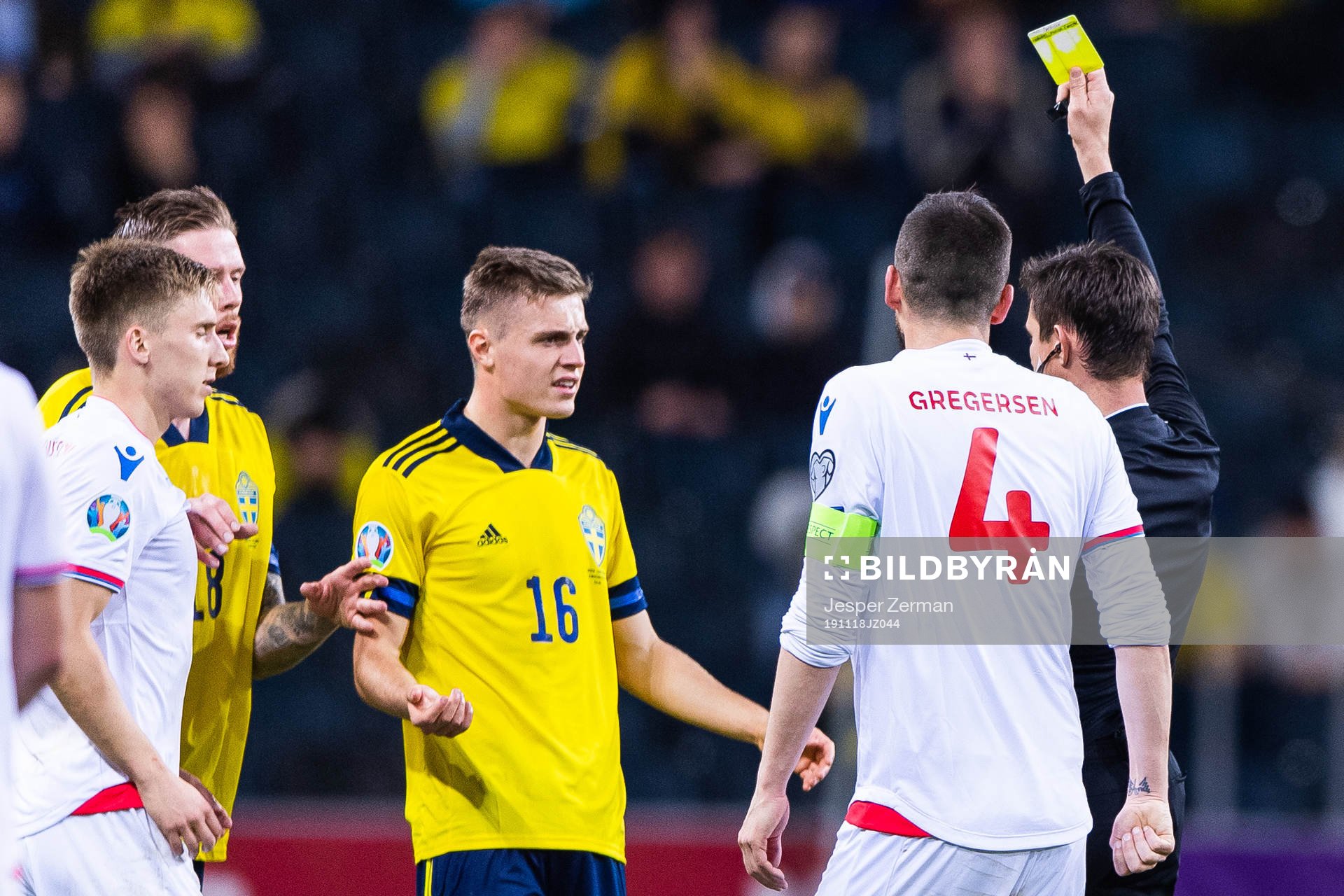 Mattias Svanberg of Sweden receives a yellow card from