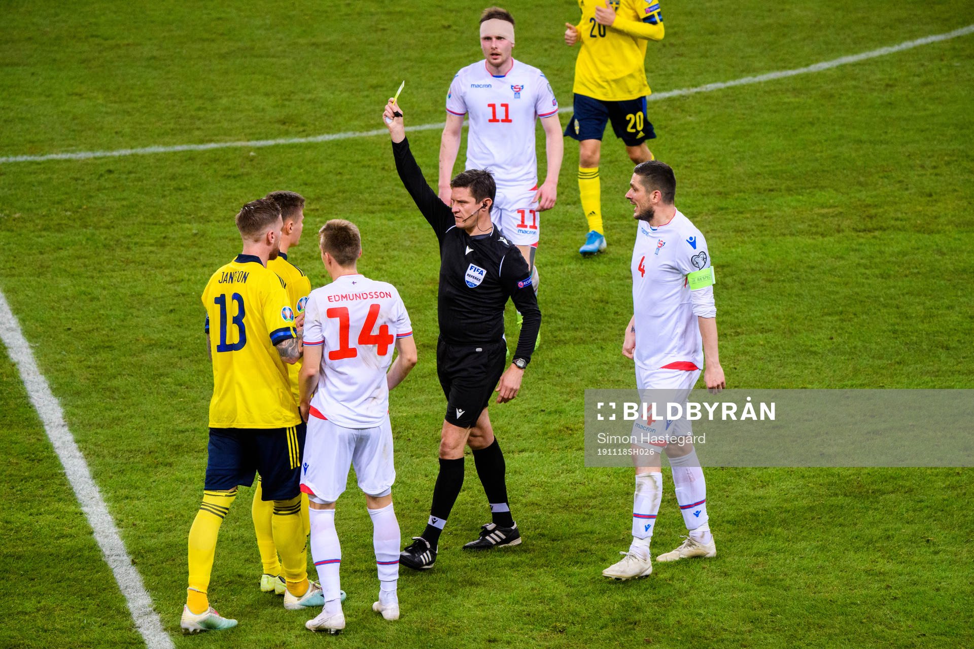 Mattias Svanberg of Sweden receives a yellow card from