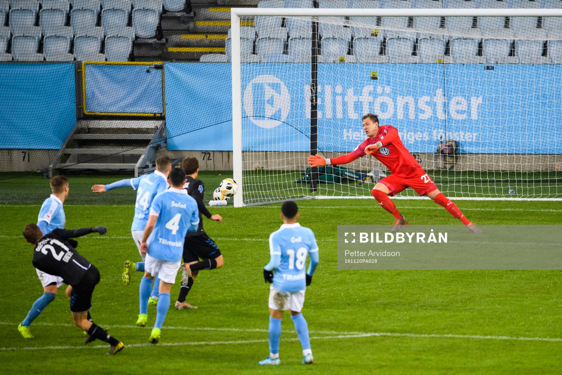 Odenses Mathias Peter Greve Petersen skjuter in 1-2 målet bakom Malmö FFs målvakt Johan Dahlin under en träningsmatch i fotboll mellan Malmö FF och Odense den 20 november 2019 i Malmö.