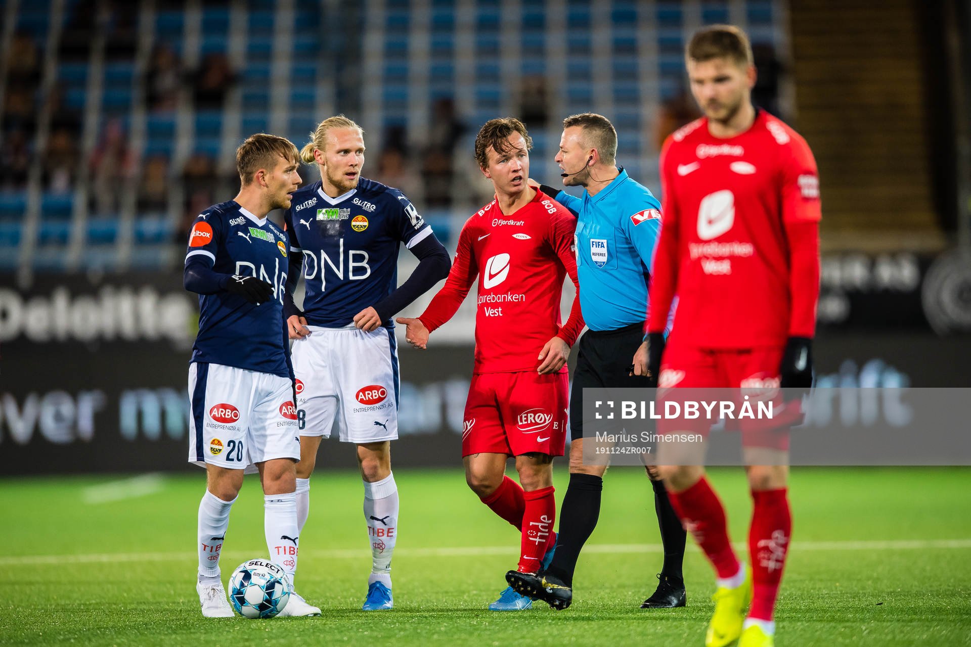 Mikkel Maigaard Jakobsen, Lars-Jørgen Salvesen of Strømsgodset, Fredrik Haugen of Brann and Svein Oddvar Moen, referee, during the Eliteserien match between Strømsgodset and brann on November 24, 2019 in Drammen.