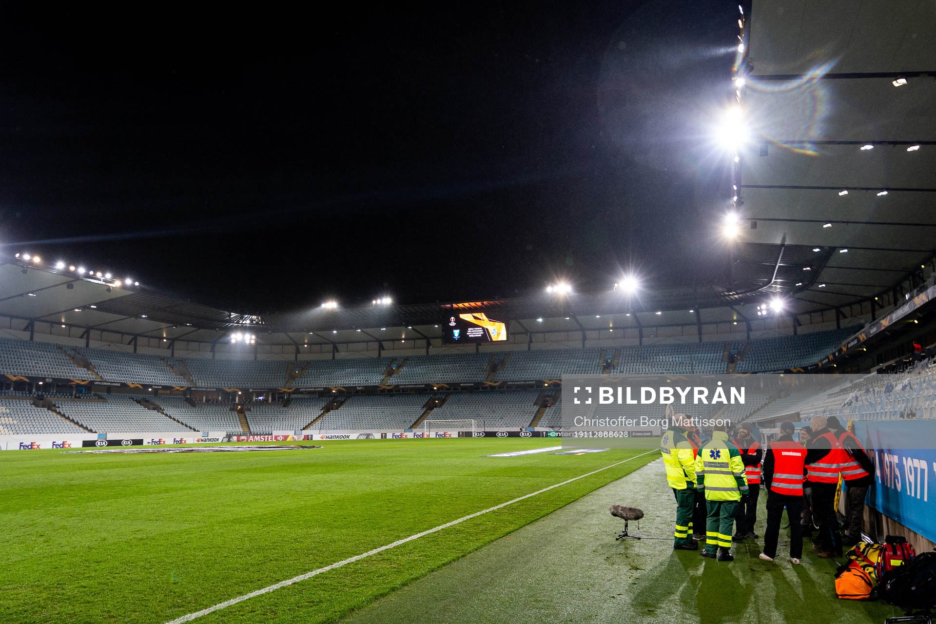 Medics and safety personnel are gathered next to the pitch