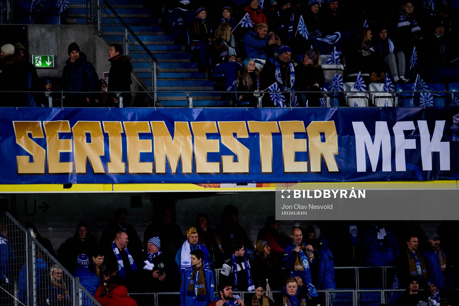 Spectators and a banner