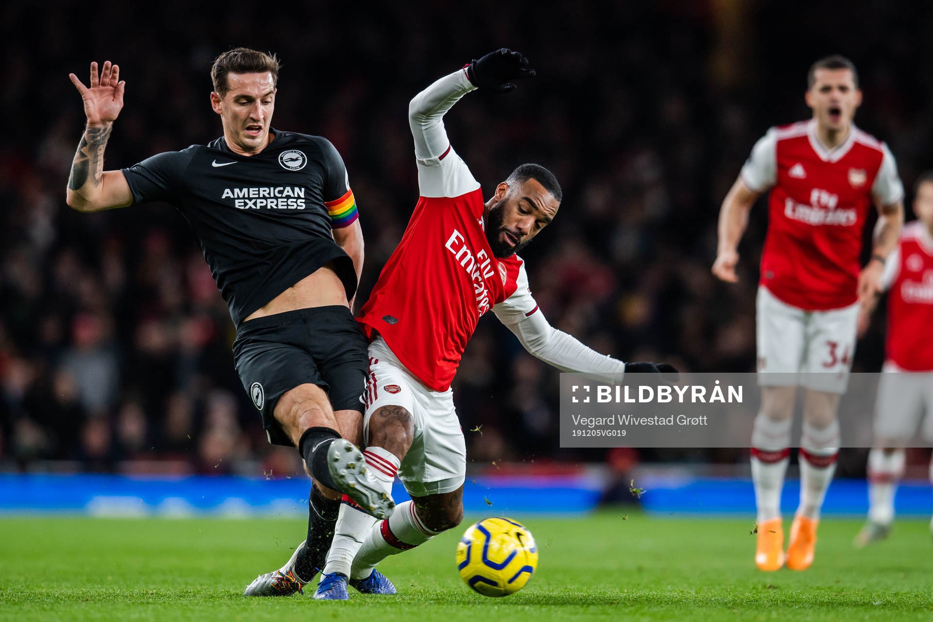Lewis Dunk of Brighton and Alexandre Lacazette of Arsenal