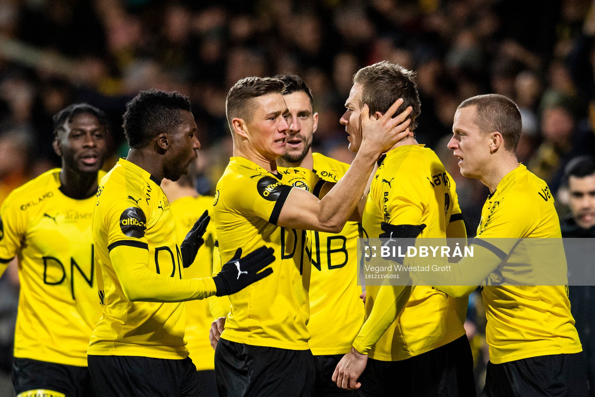 Simen Kind Mikalsen of Lillestrøm celebrates with teammates after scoring 1-0 during the Eliteserien playoff football match between Lillestrøm and Start on December 11, 2019 in Lillestrøm.