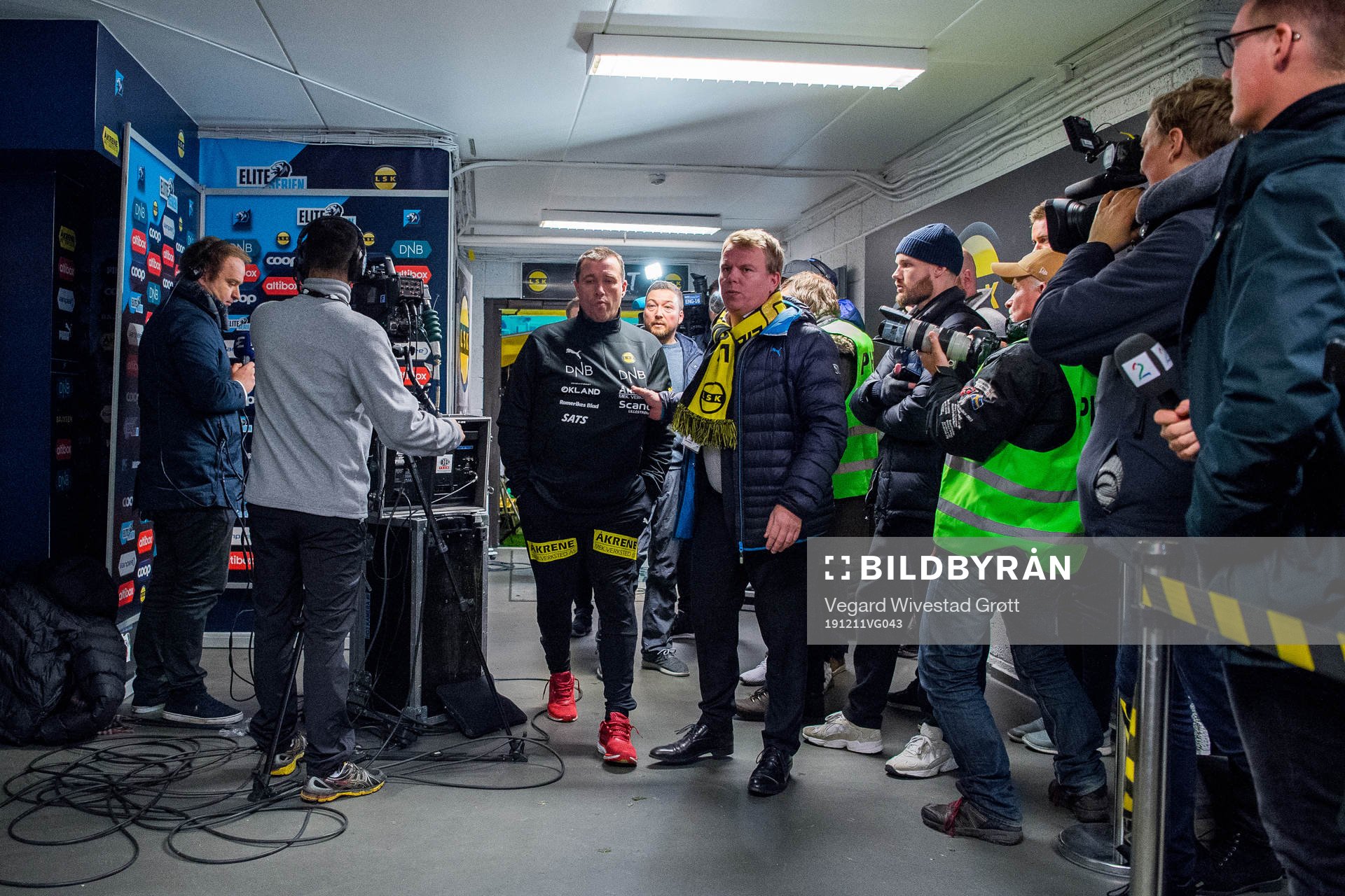 Tom Nordlie, head coach of Lillestrøm, and Morten Stokstad, head of media at Lillestrøm, in the mixed zone after the Eliteserien playoff football match between Lillestrøm and Start on December 11, 2019 in Lillestrøm.