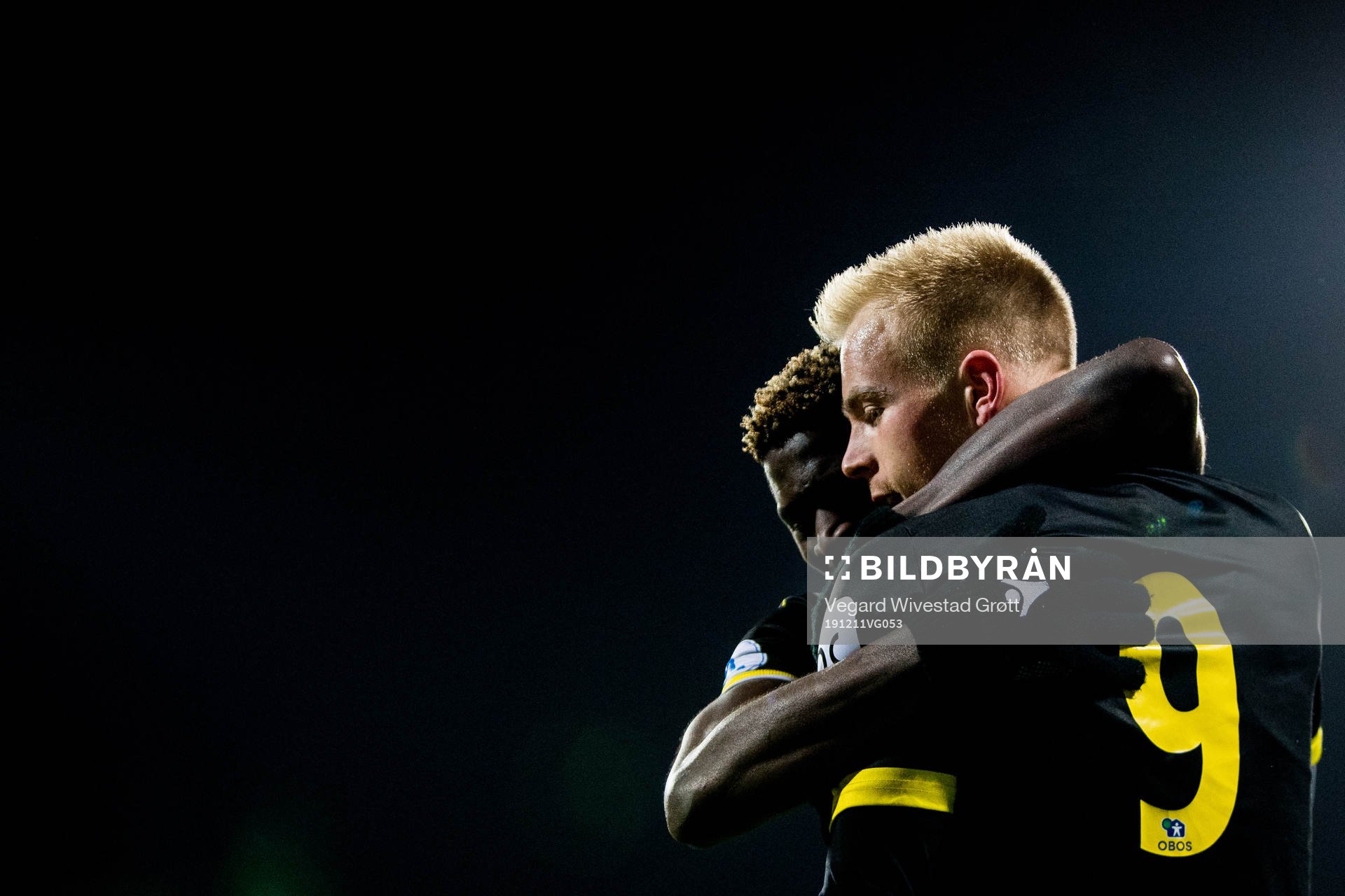 Martin Ramsland of Start celebrates with teammate Afeez Aremu after scoring 4-3 during the Eliteserien playoff football match between Lillestrøm and Start on December 11, 2019 in Lillestrøm.