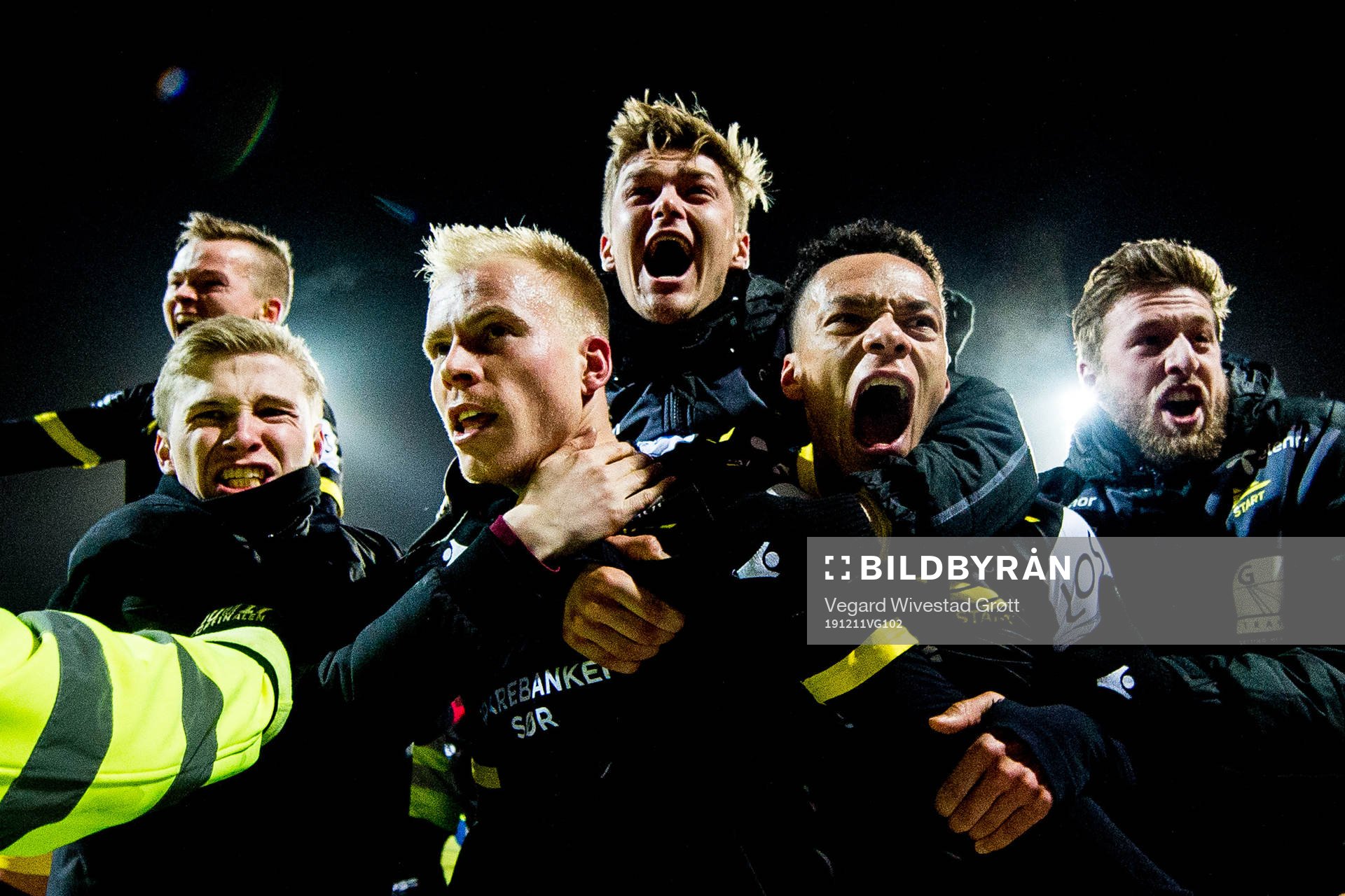 Martin Ramsland of Start celebrates with Mathias Idsøe Bringaker, Isaac Twum and teammates after scoring 4-3 during the Eliteserien playoff football match between Lillestrøm and Start on December 11, 2019 in Lillestrøm.