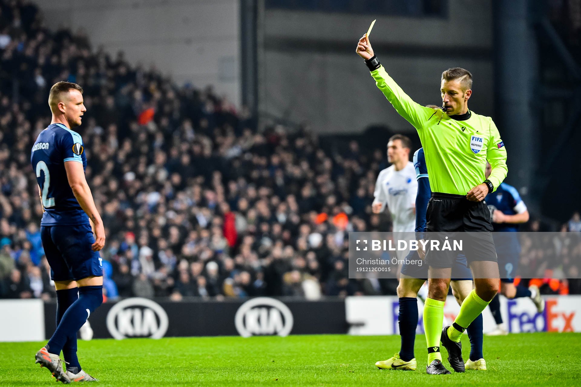 Eric Larsson of Malmö FF receives a yellow card from