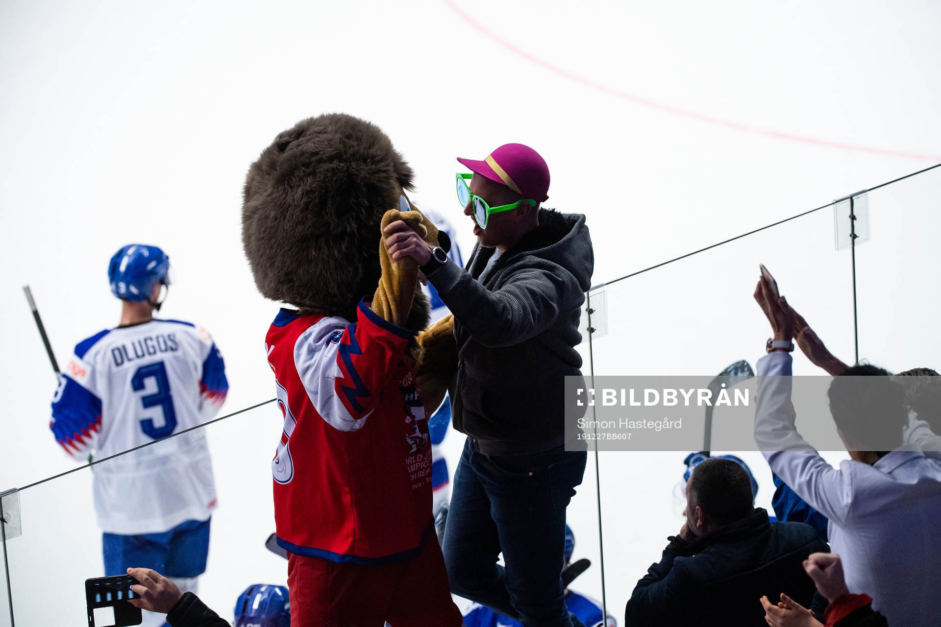 Fans of Slovakia celebrate with the official mascot