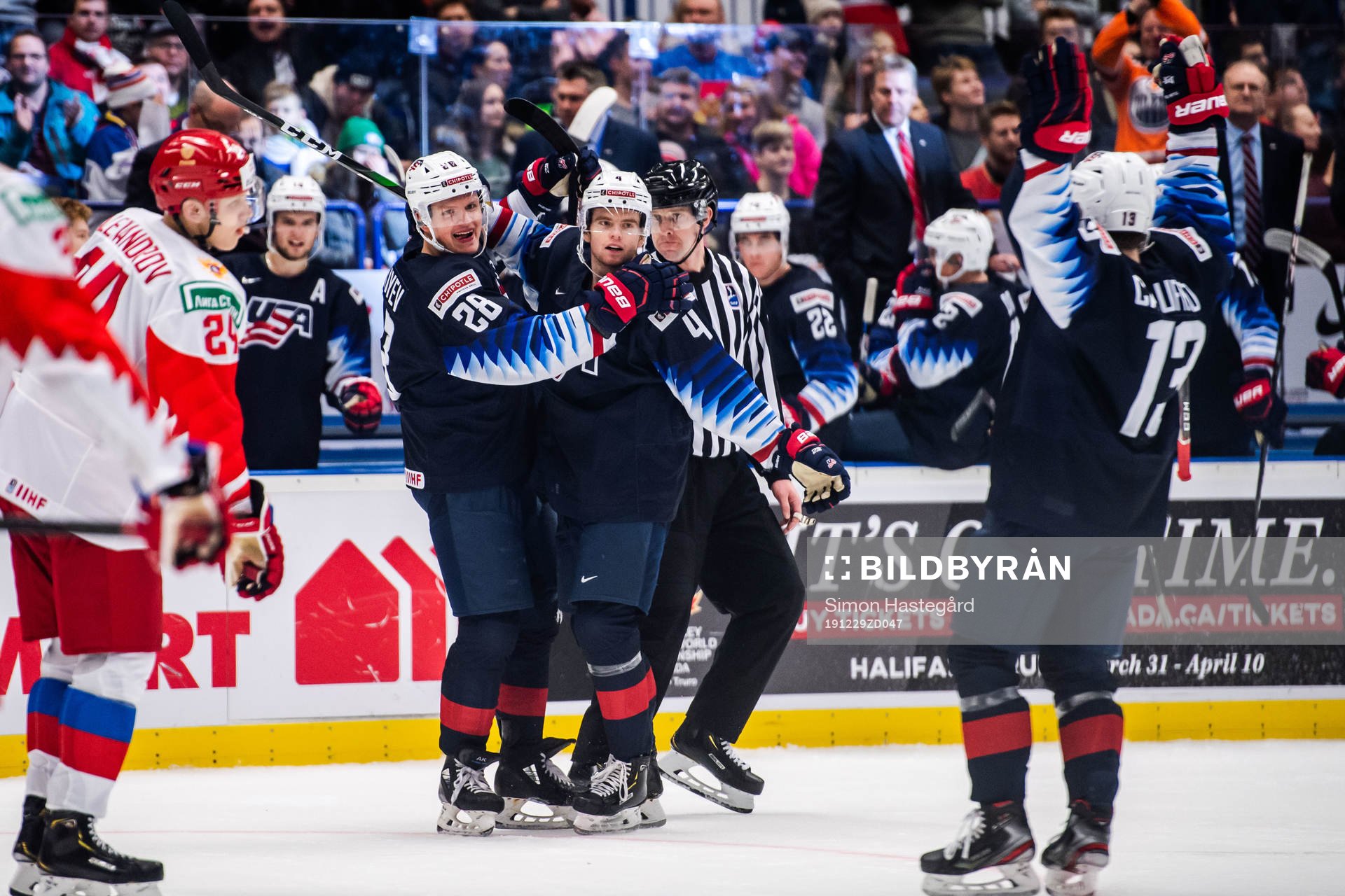 Arthur Kaliyev, Cole Caufield and Cam York of USA  celebrate