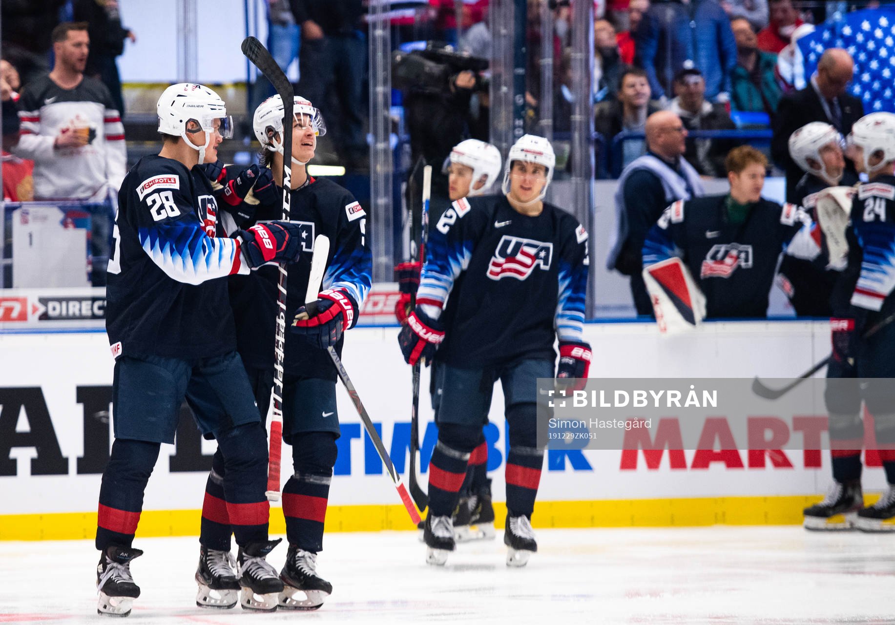 Arthur Kaliyev and Trevor Zegras of USA celebrate the 0-3
