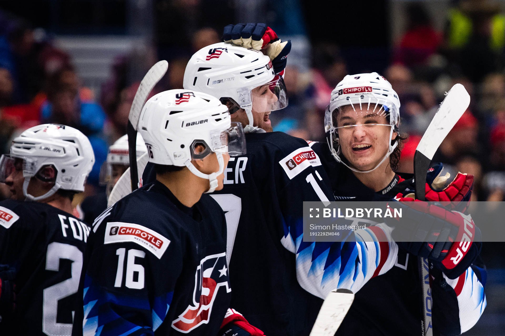 John Beecher and Trevor Zegras of USA celebrate