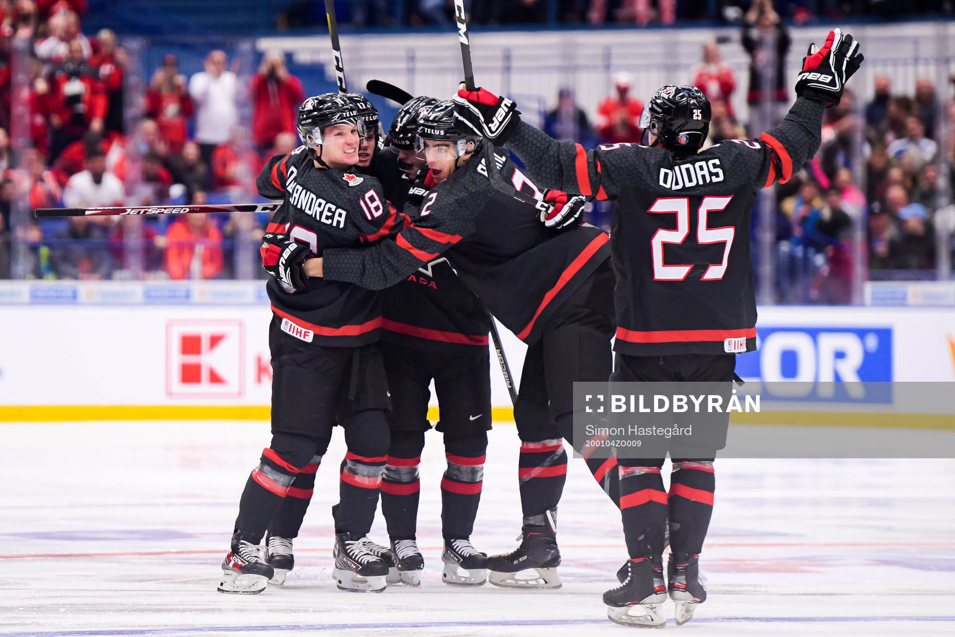 Ty Dellandrea, Kevin Bahl and Aidan Dudas celebrate the 1-0