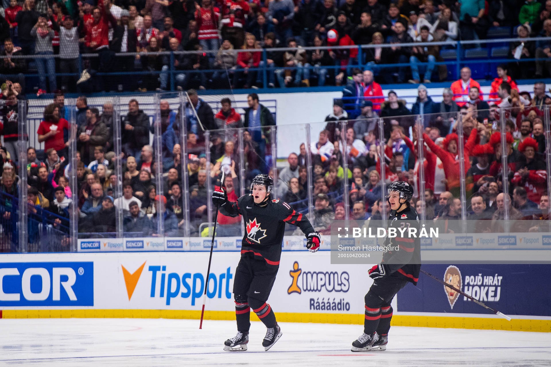 Alexis Lafreniere and Barrett Hayton of Canada celebrates