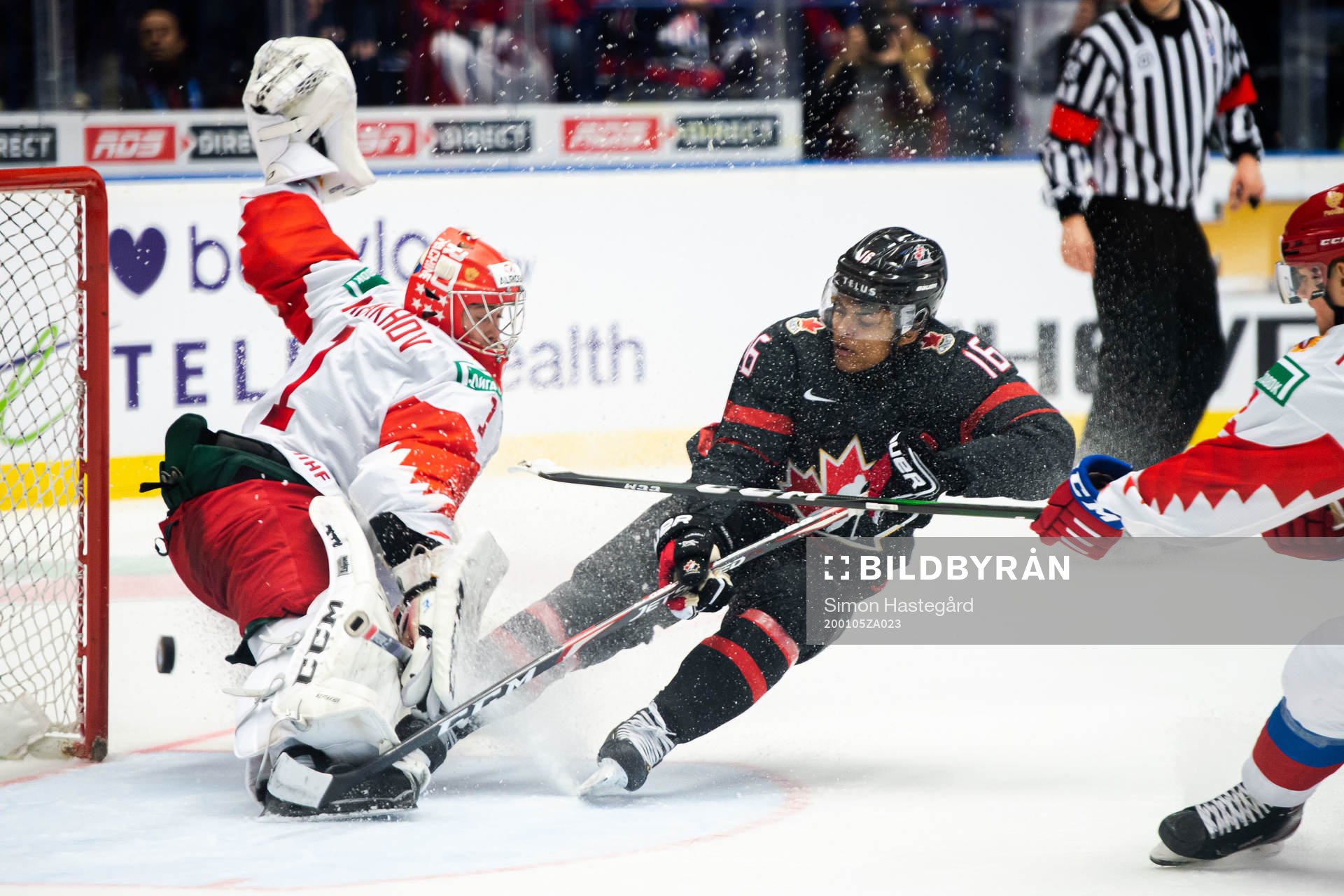 Akil Thomas of Canada scores 4-3 behind goalkeeper Amir
