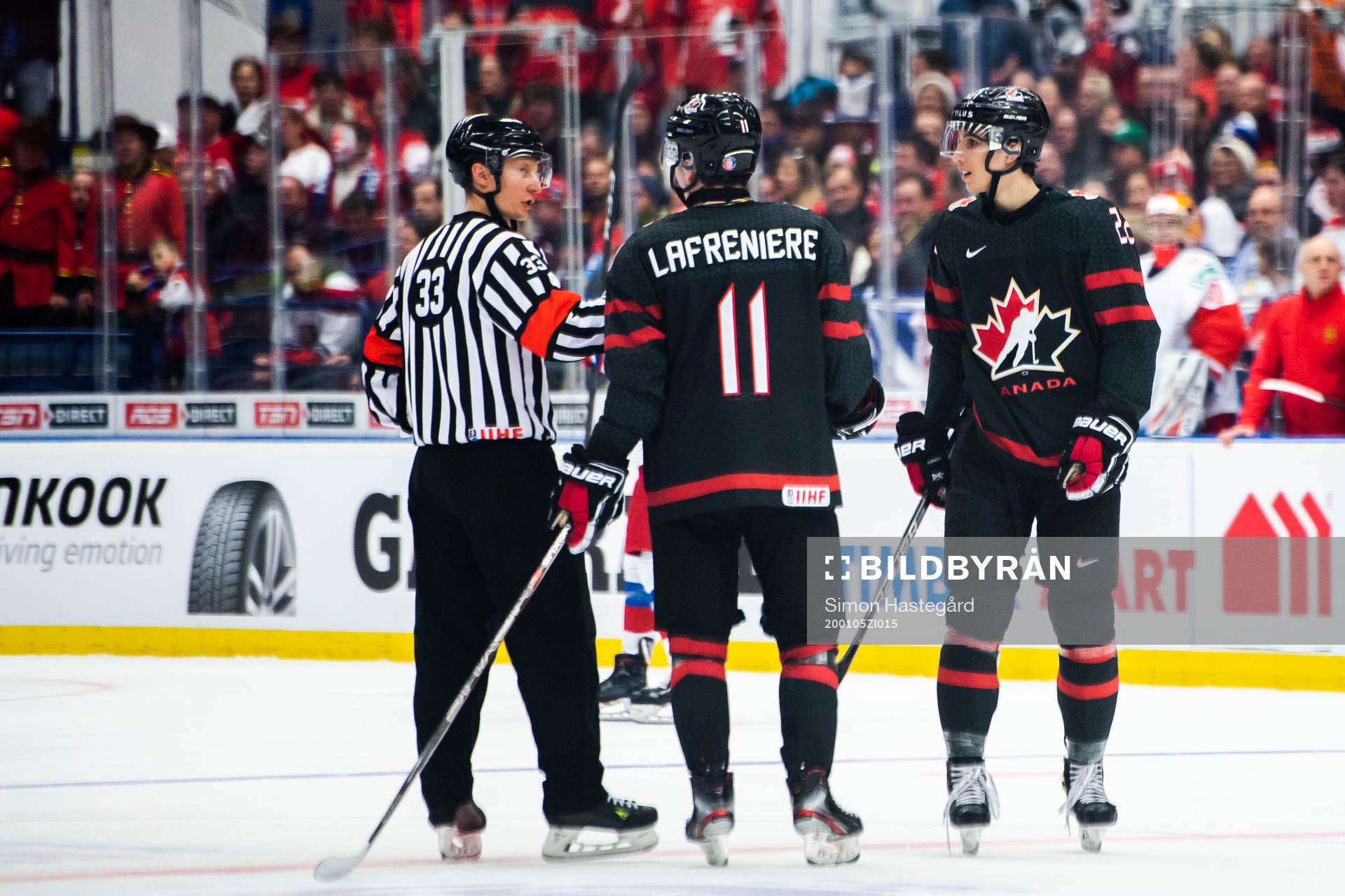 Alexis Lafreniere and Dylan Cozens of Canada in a