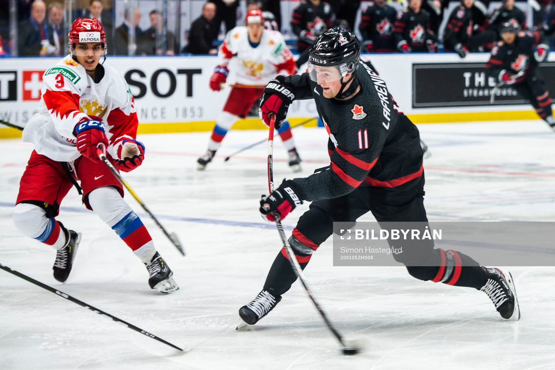Danila Galenyuk of Russia and Alexis Lafreniere of Canada