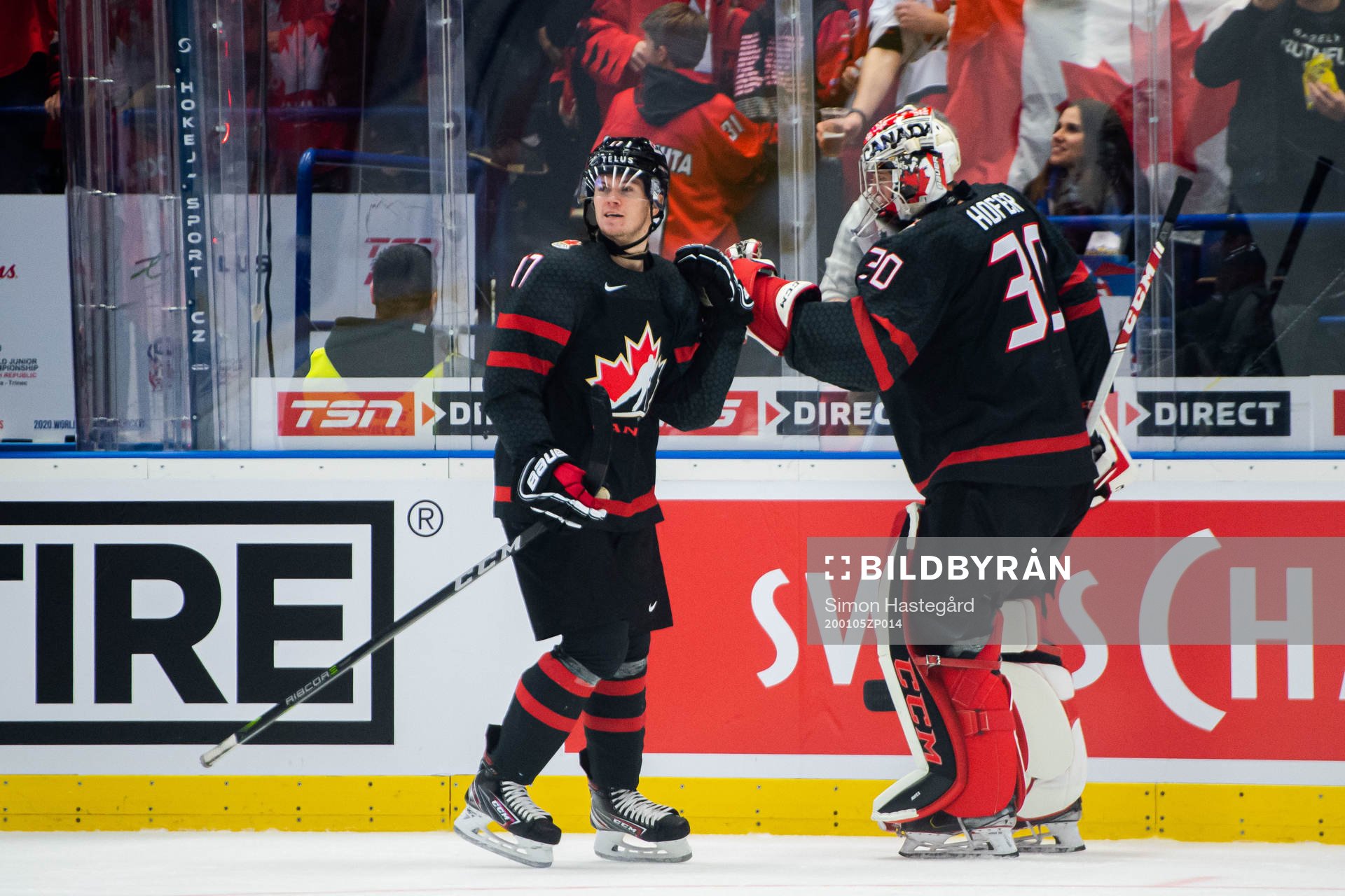 Connor McMichael and goalkeeper Joel Hofer of Canada