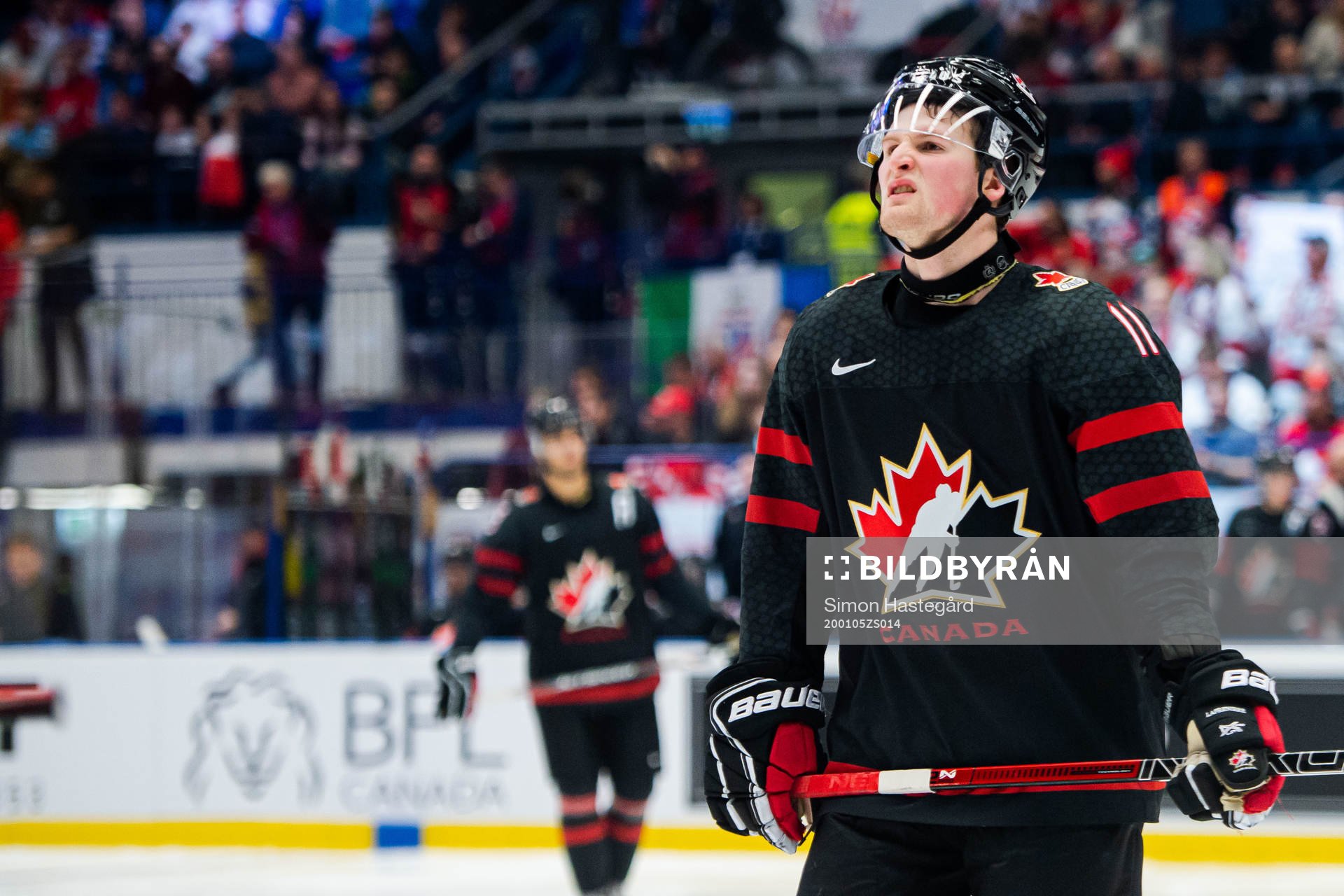 Alexis Lafreniere of Canada looks dejected