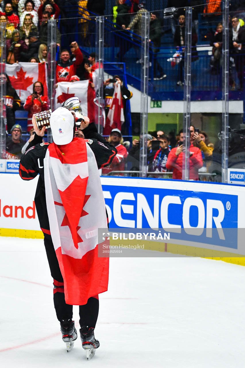 Alexis Lafreniere of Canada celebrate with the trophy and a