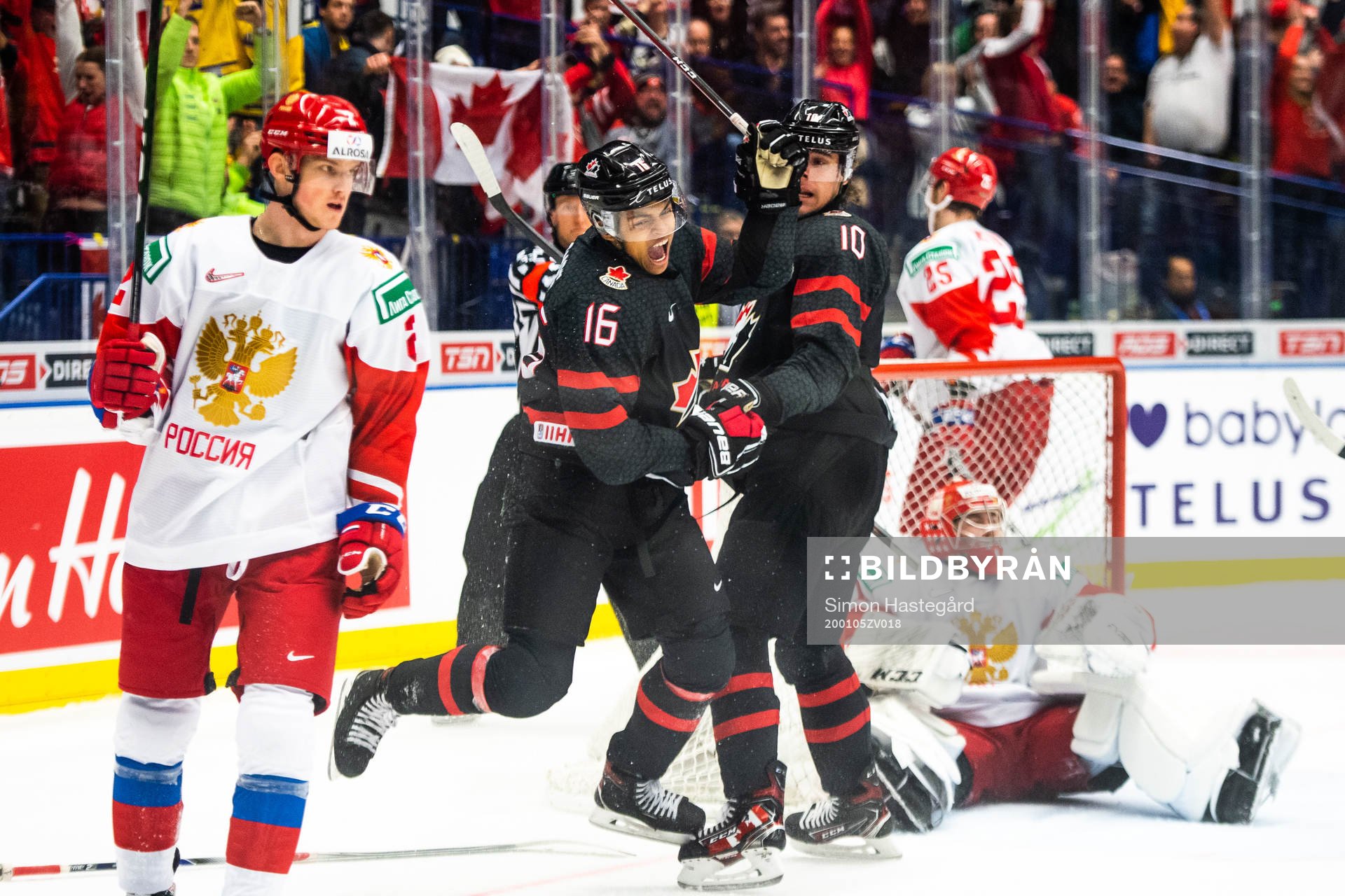 Akil Thomas and Raphael Lavoie of Canada celebrate the 4-3