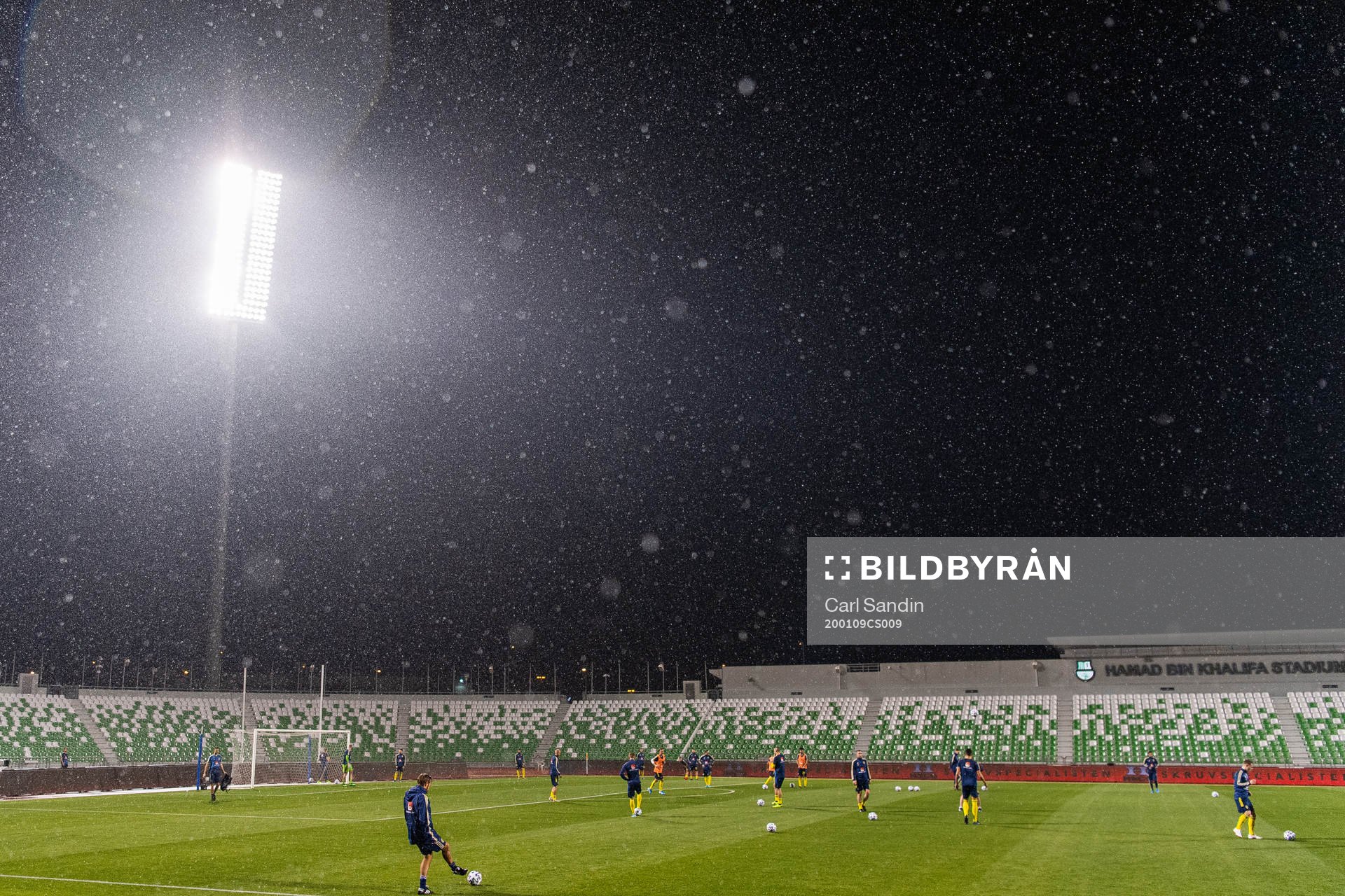 Players are seen warming up in rainfall