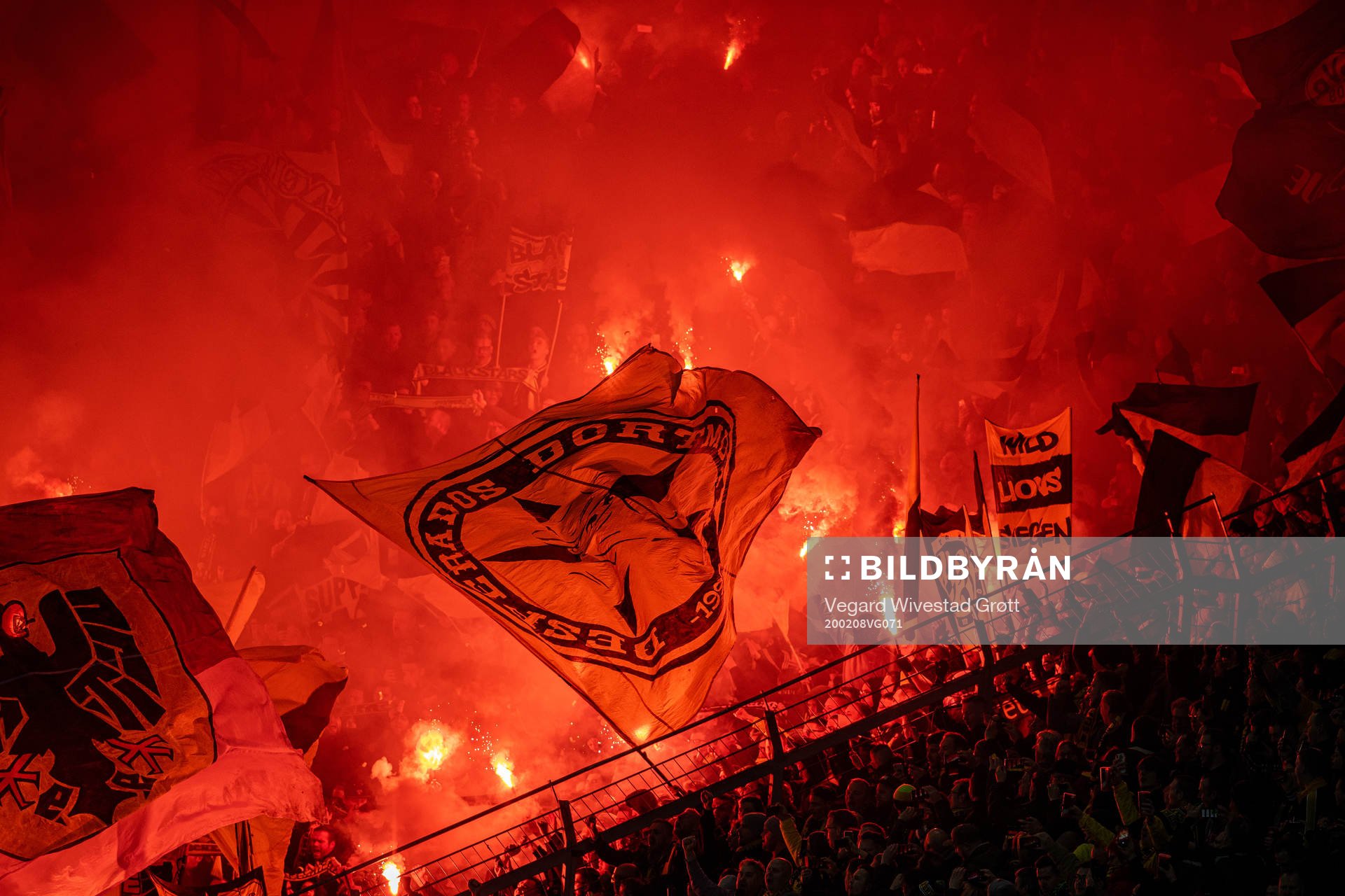 Supporters of Borussia Dortmund with pyro during the Bundesliga football match between Bayer Leverkusen and Borussia Dortmund on February 8, 2020 in Leverkusen.