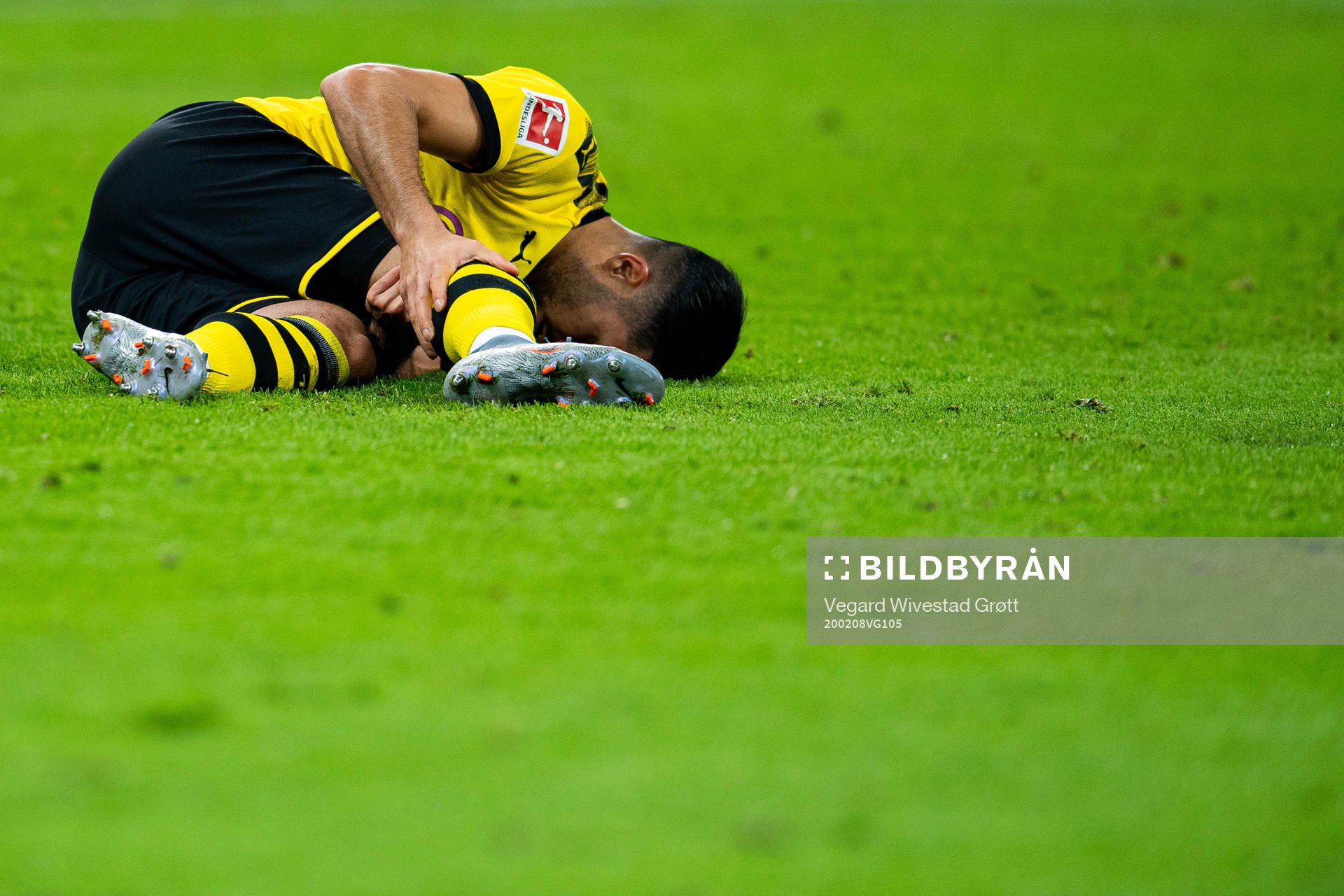 Emre Can of Borussia Dortmund lies down with an injury