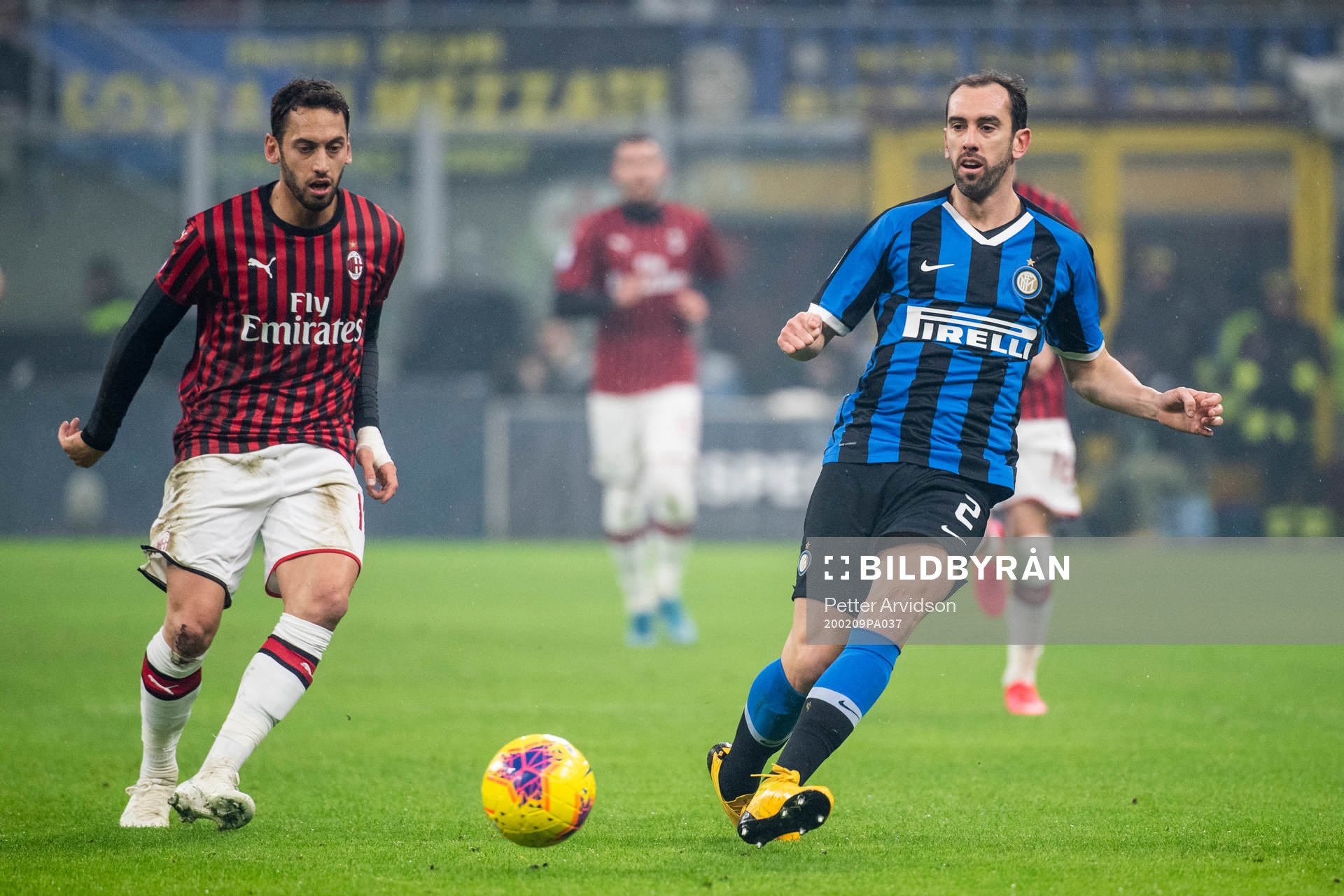 Hakan Calhanoglu of Milan and Diego Godin of Inter