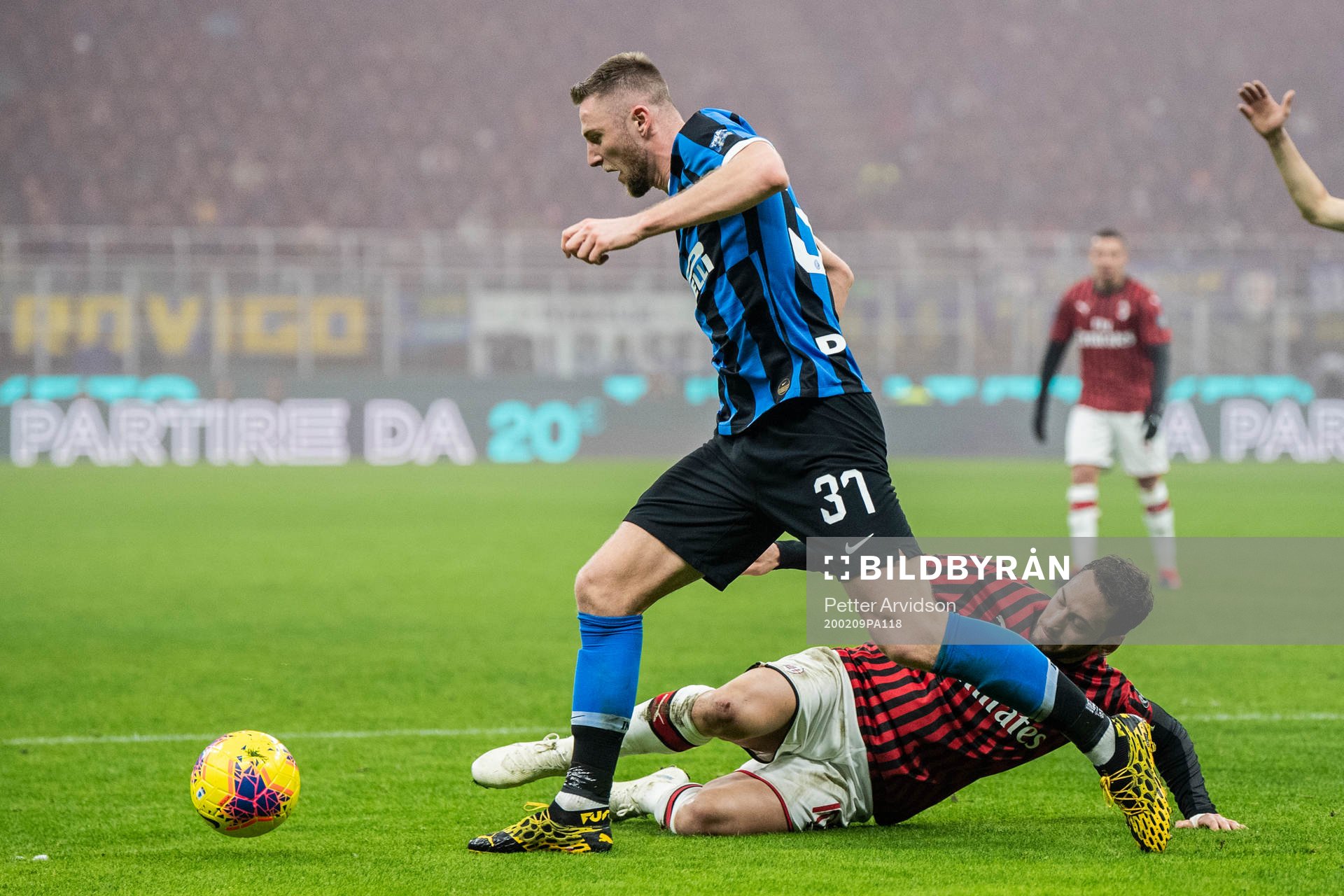 Milan Skriniar of Inter and Hakan Calhanoglu of Milan