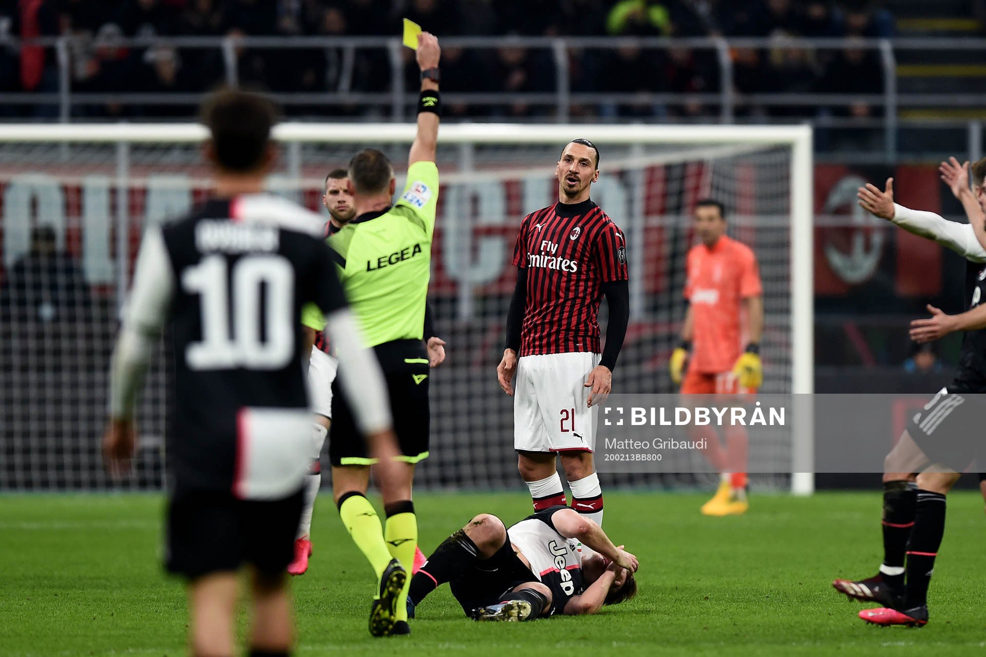 Zlatan Ibrahimovic of AC Milan receives a yellow card