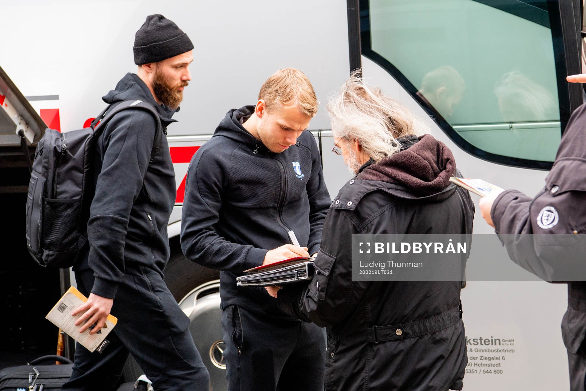 Oscar Lewicki of Malmö FF signs autographs as he  arrives