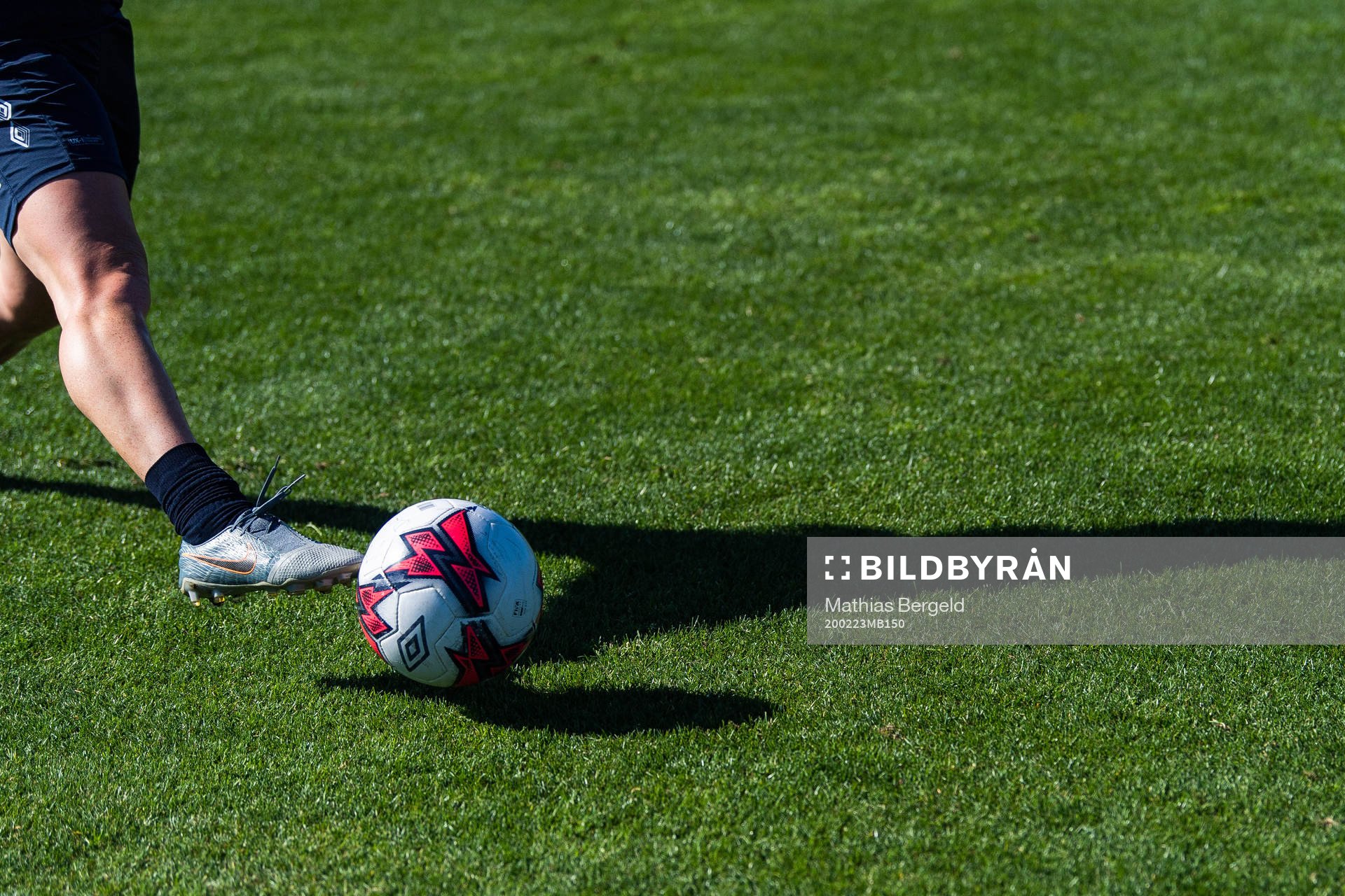 A shadow of a player and a football