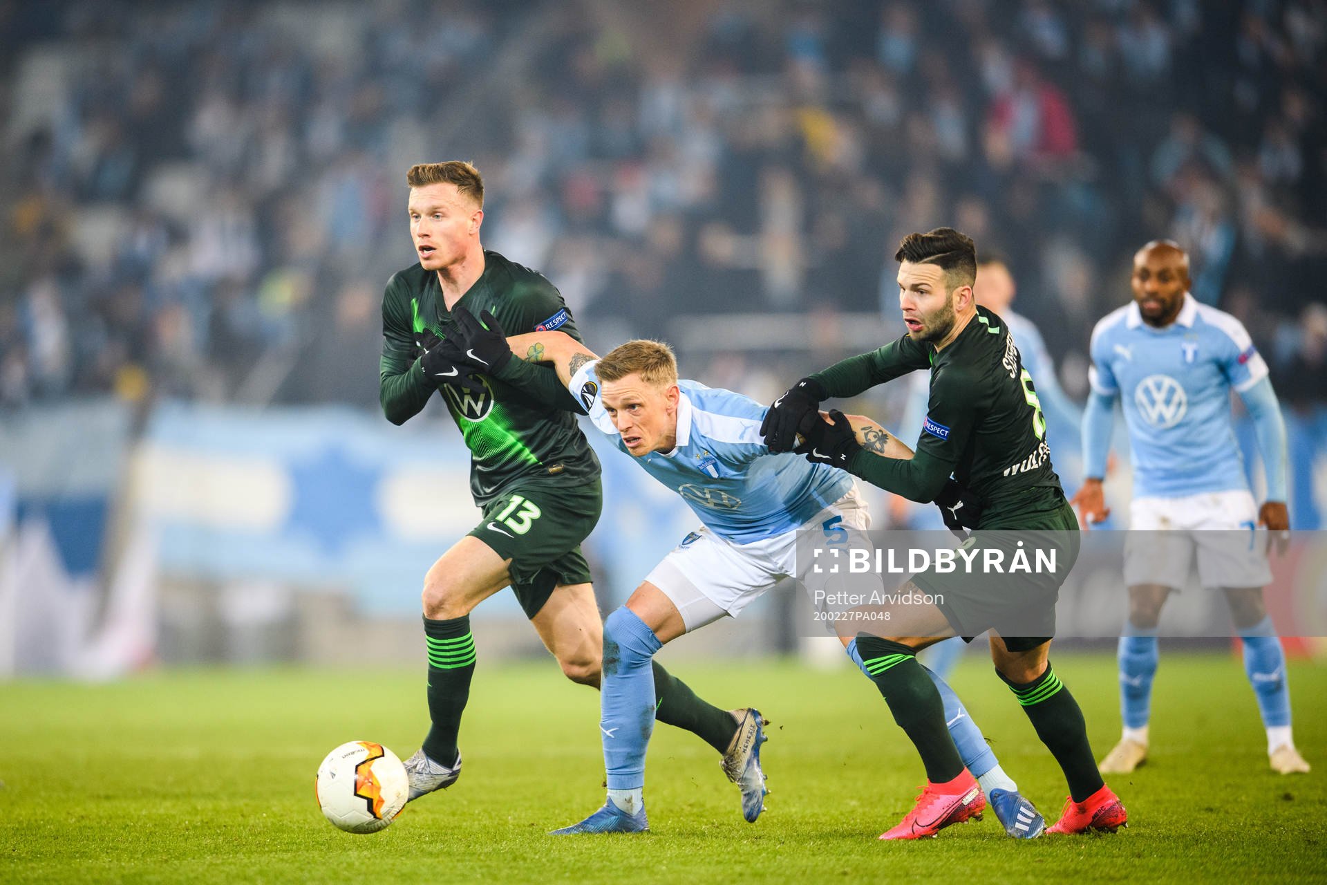 Sören Rieks of Malmö FF against Yannick Gerhardt and Renato Steffen of Wolfsburg during of the Europa Leauge match between Malmö FF and Wolfsburg on February 27, 2020 in Malmö.