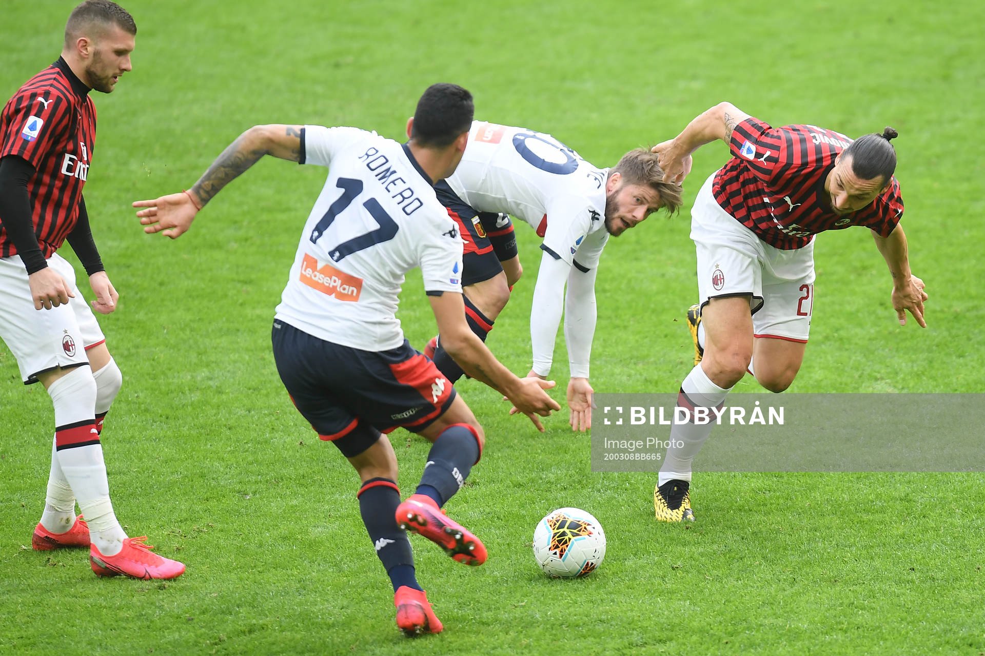 Zlatan Ibrahimovic of Milan and Cristian Romero of Genoa