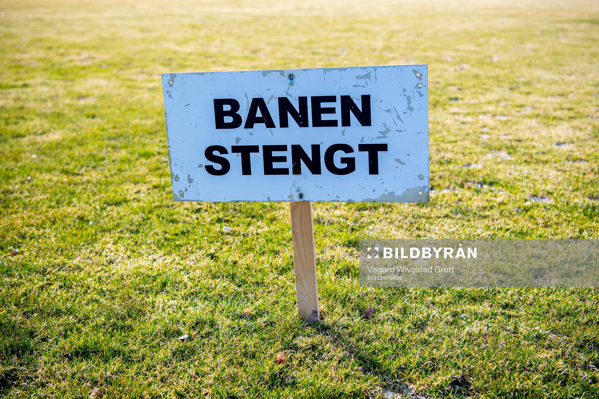A sign states that the football field is closed as the