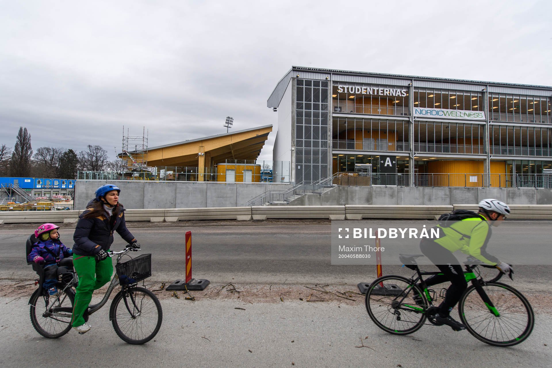 Two cyclists pass Studenternas IP as the coronavirus,