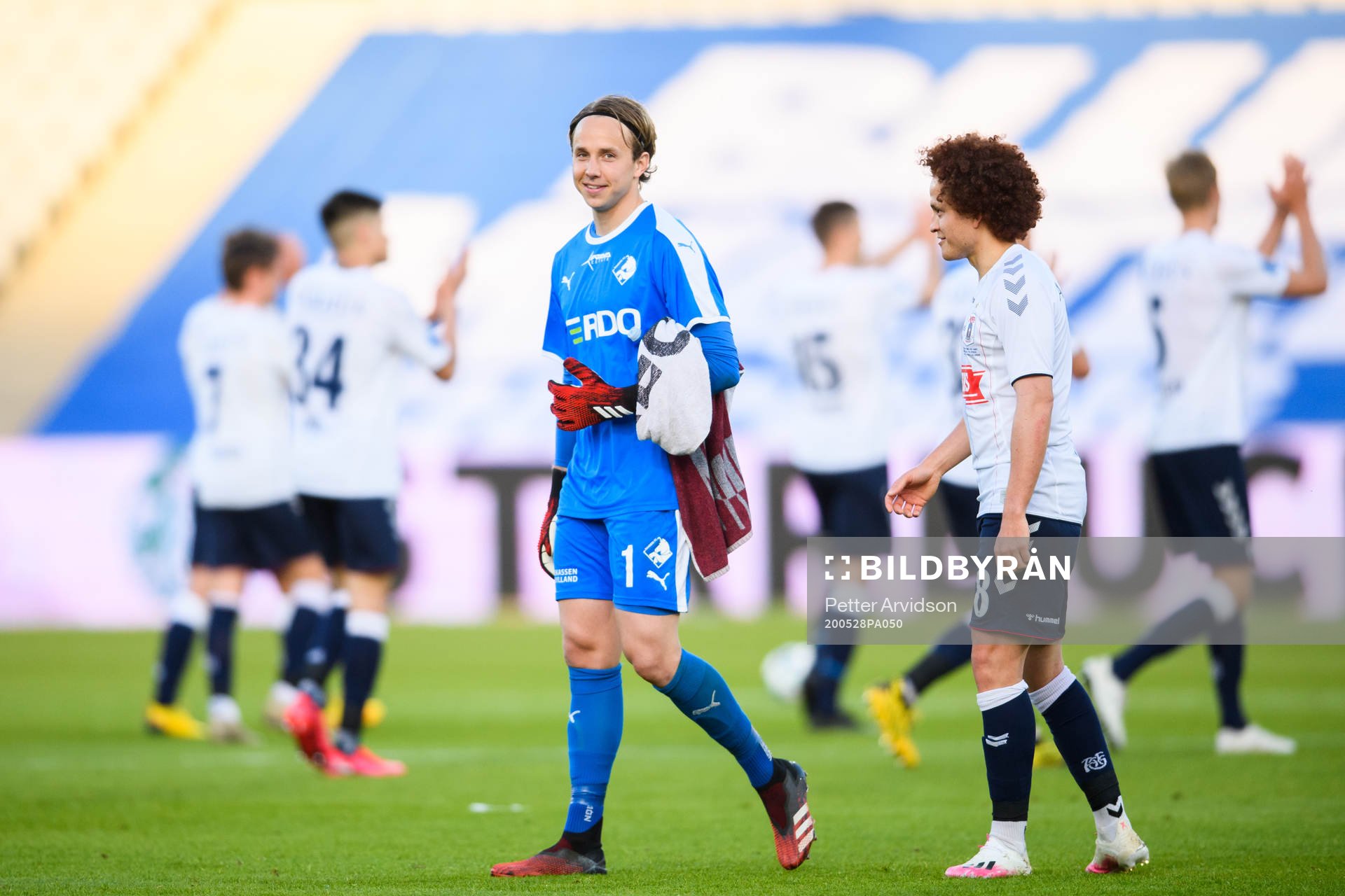 Goalkeeper Patrik Carlgren of Randers and Mustafa Amini of