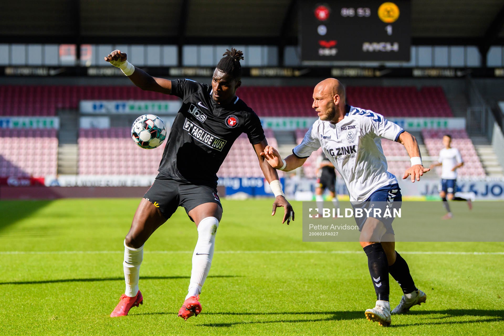 Sory Kaba of Midtjylland and Michael Lump of Horsens during the Danish Superliga match between FC Midtjylland and AC Horsens on July 1, 2020 in Herning.