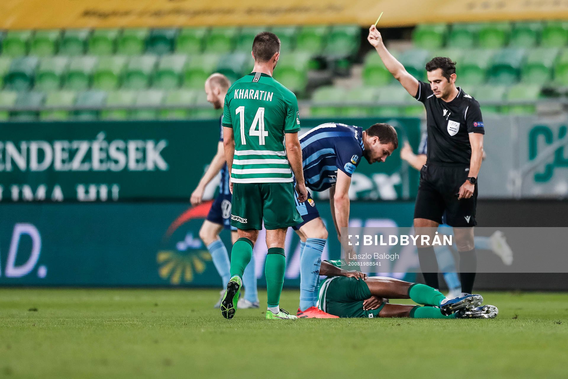 Referee Fedayi San shows a yellow card to Erik Berg of Djurgården during the UEFA Champions League qualifying match between Ferencvaros and Djurgården on August 19, 2020 in Budapest.