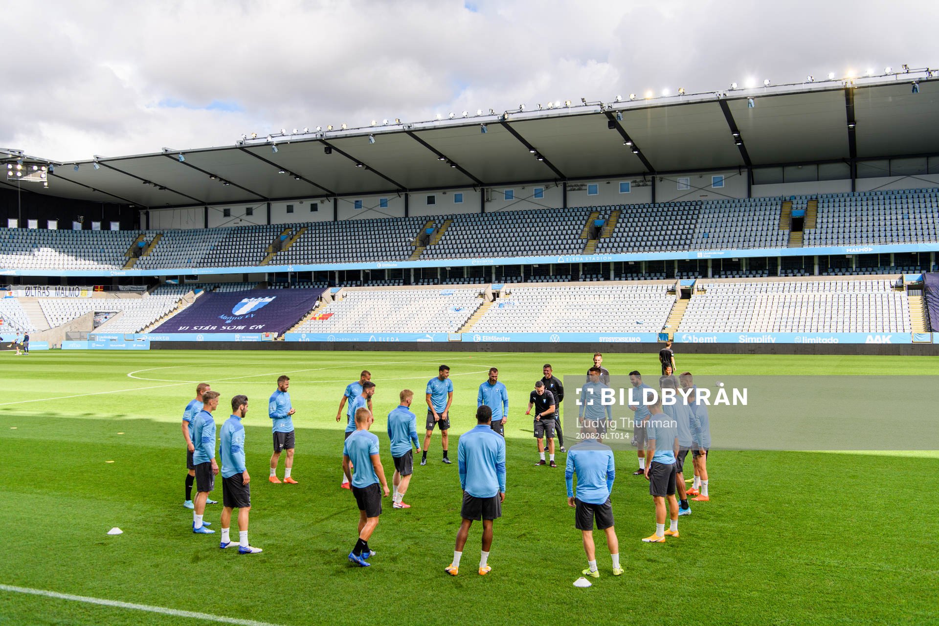 Players of Malmö FF warm up head of a practice and press