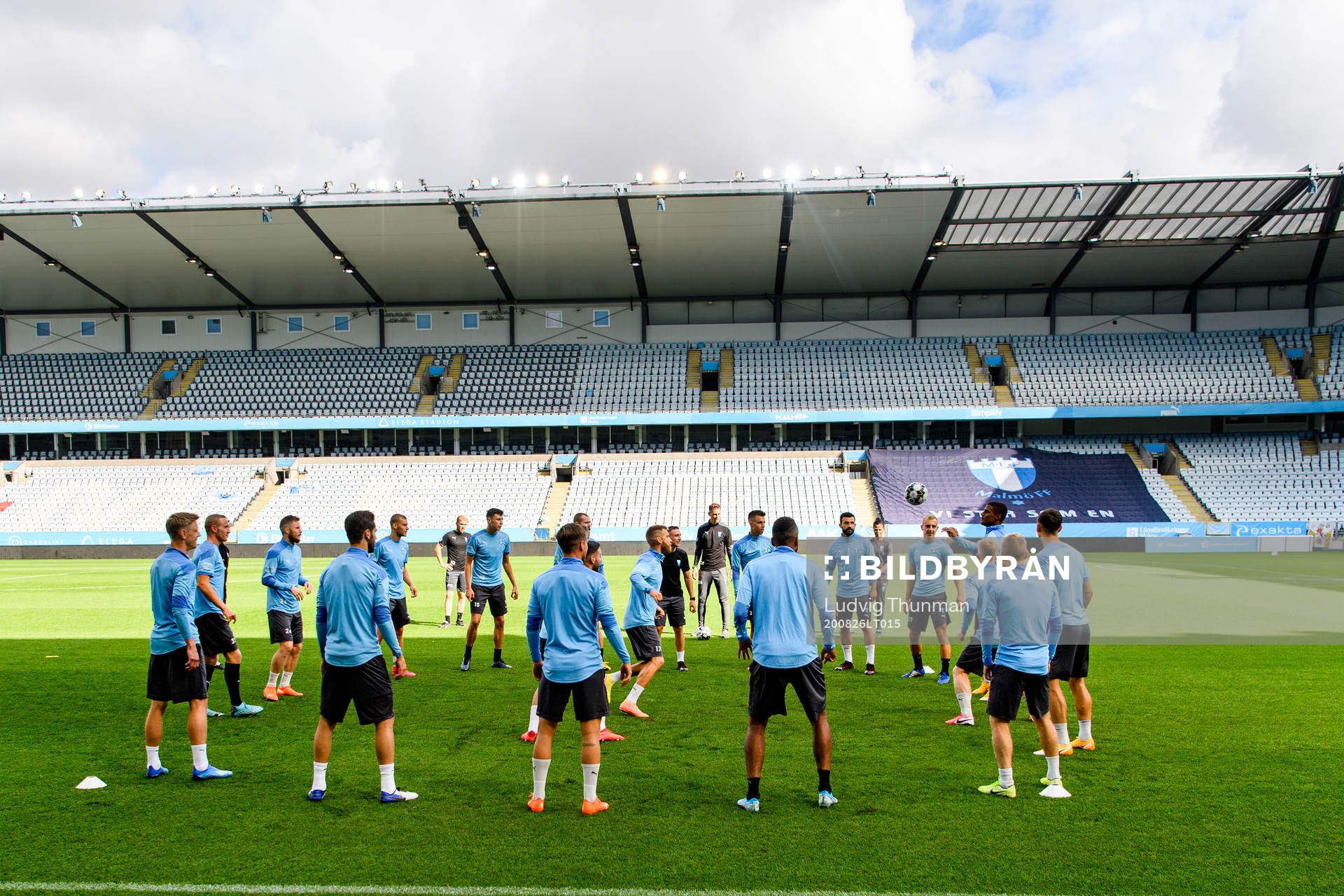 Players of Malmö FF warm up head of a practice and press