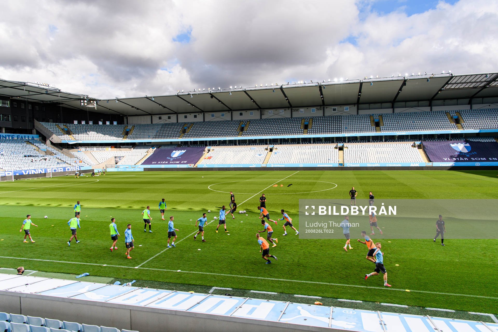 Players of Malmö FF warm up head of a practice and press