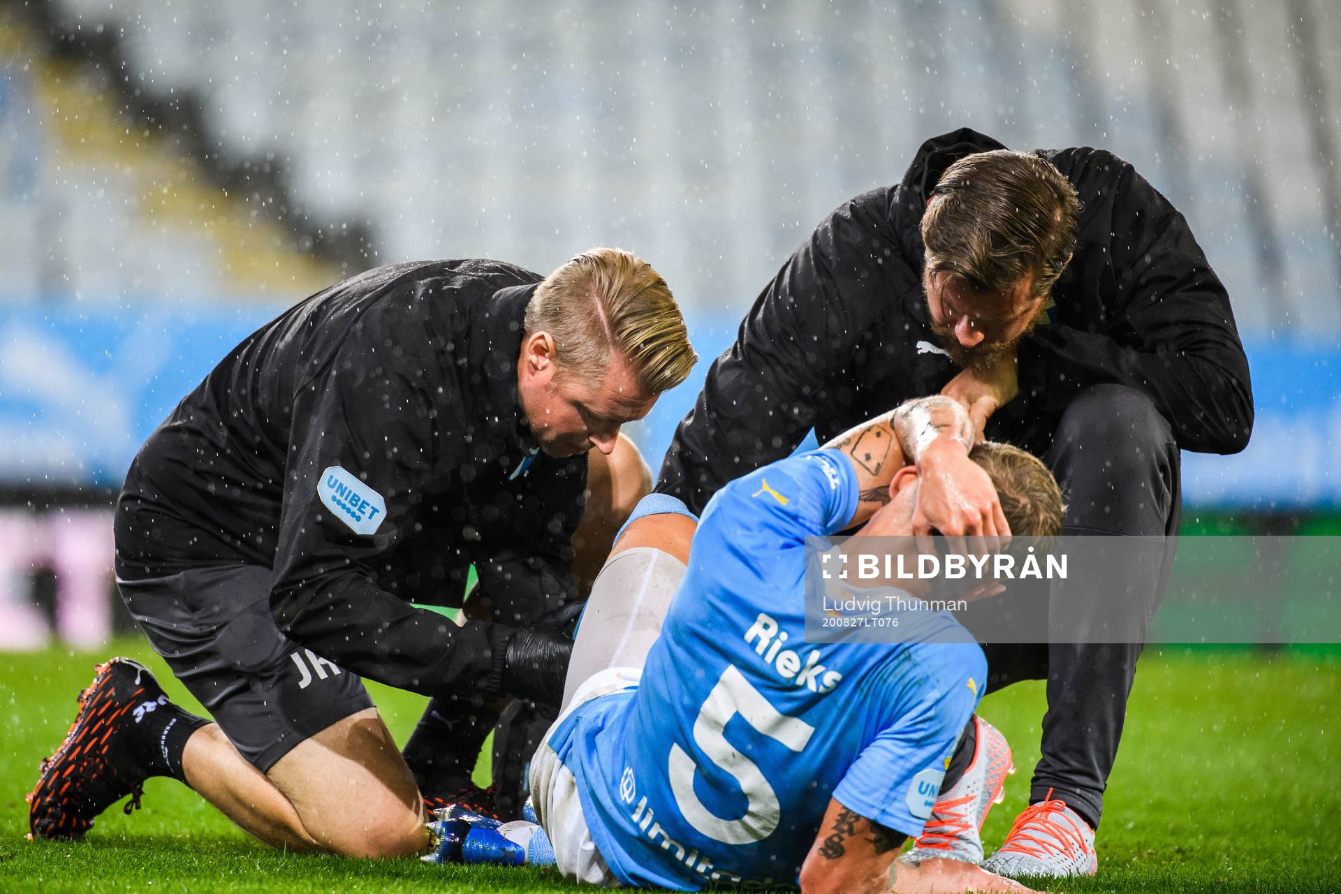 Sören Rieks of Malmö FF receives medical treatment from Jesper Robertsson, fysio, and Ola Svejme, doctor, during the UEFA Europa League qualifying match between Malmö FF and Cracovia Krakow on August 27, 2020 in Malmö.