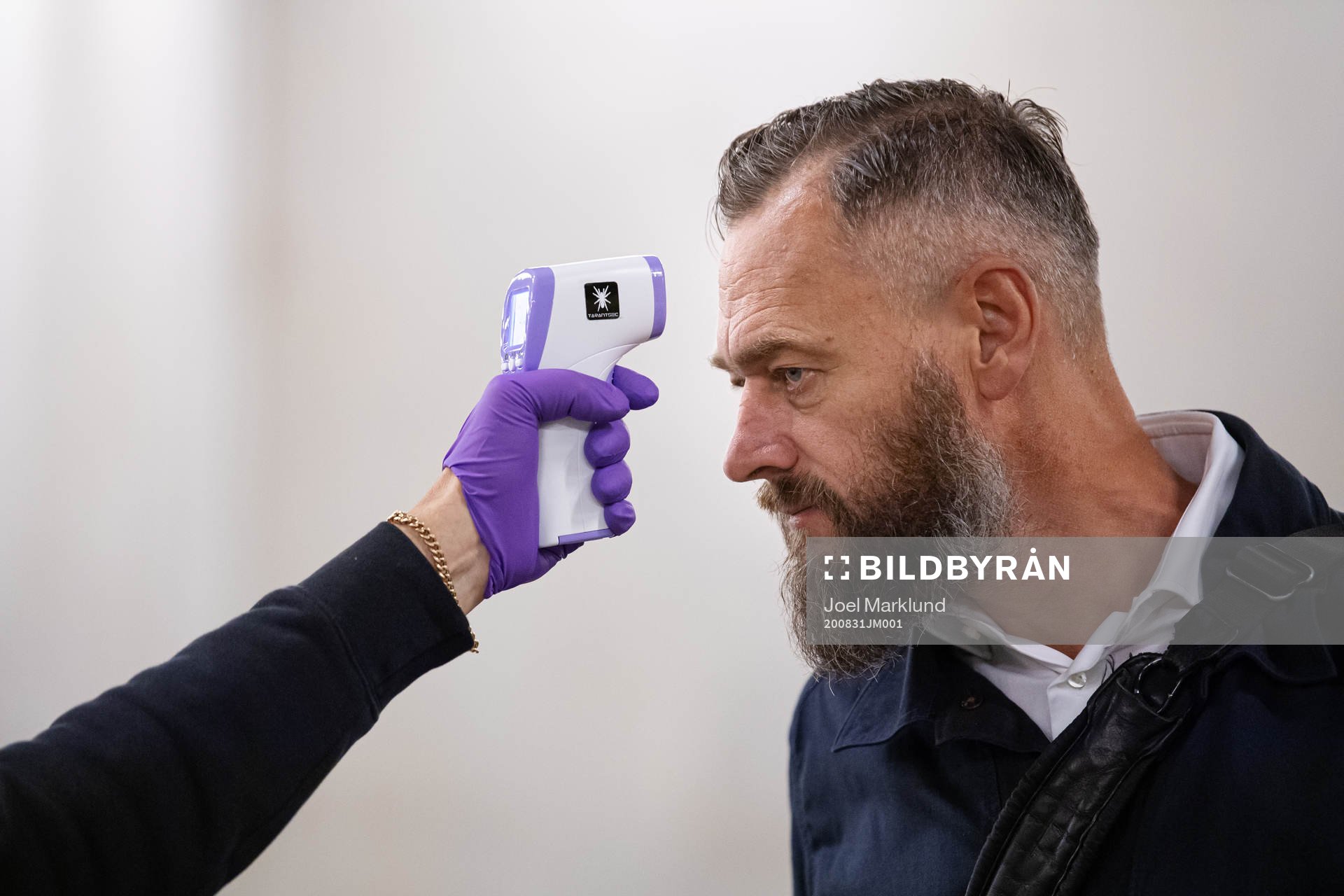 Swedish journalist Olof Lundh has his temperature checked