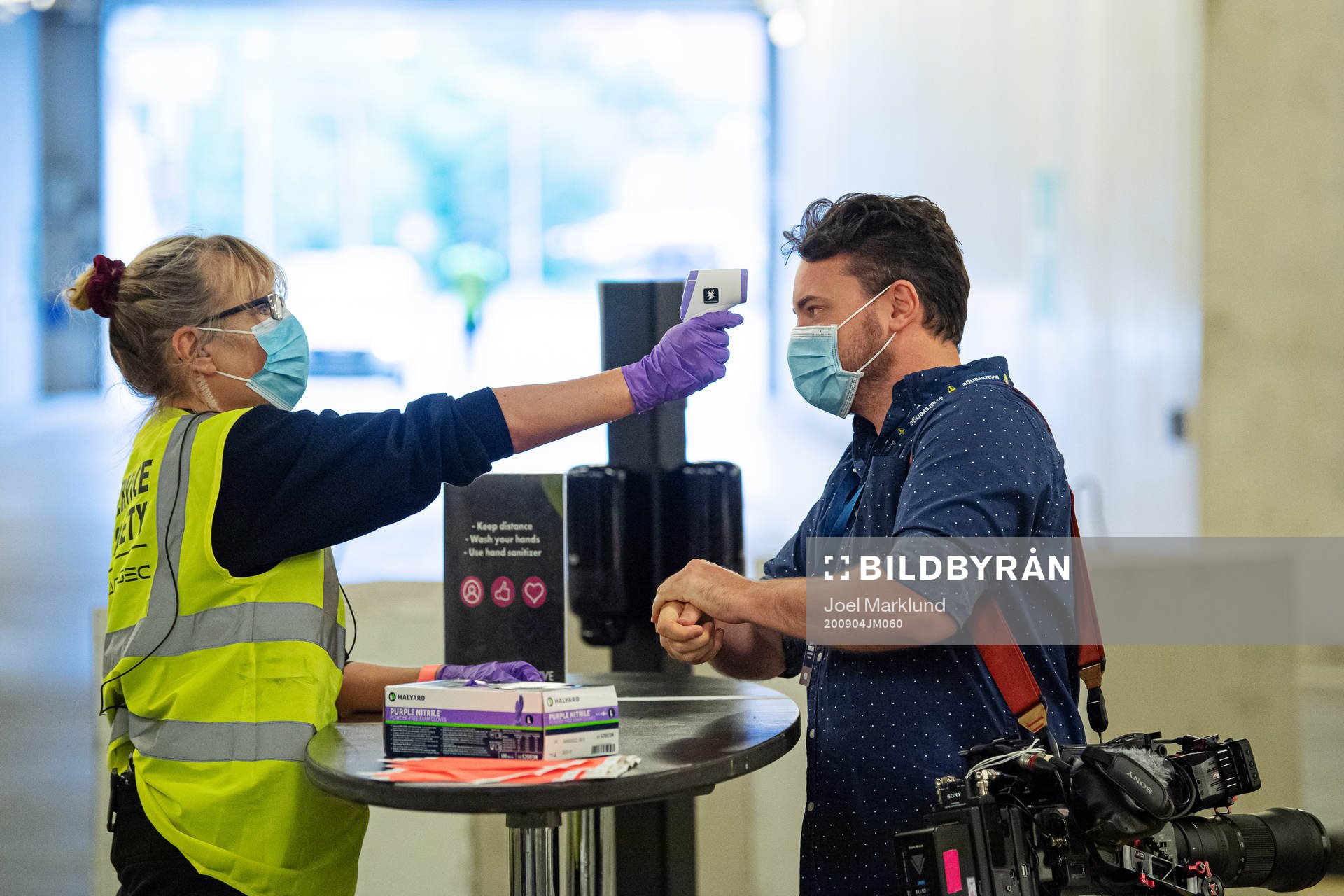Videographer Oscar Dahl of TV4 has his temperature checked