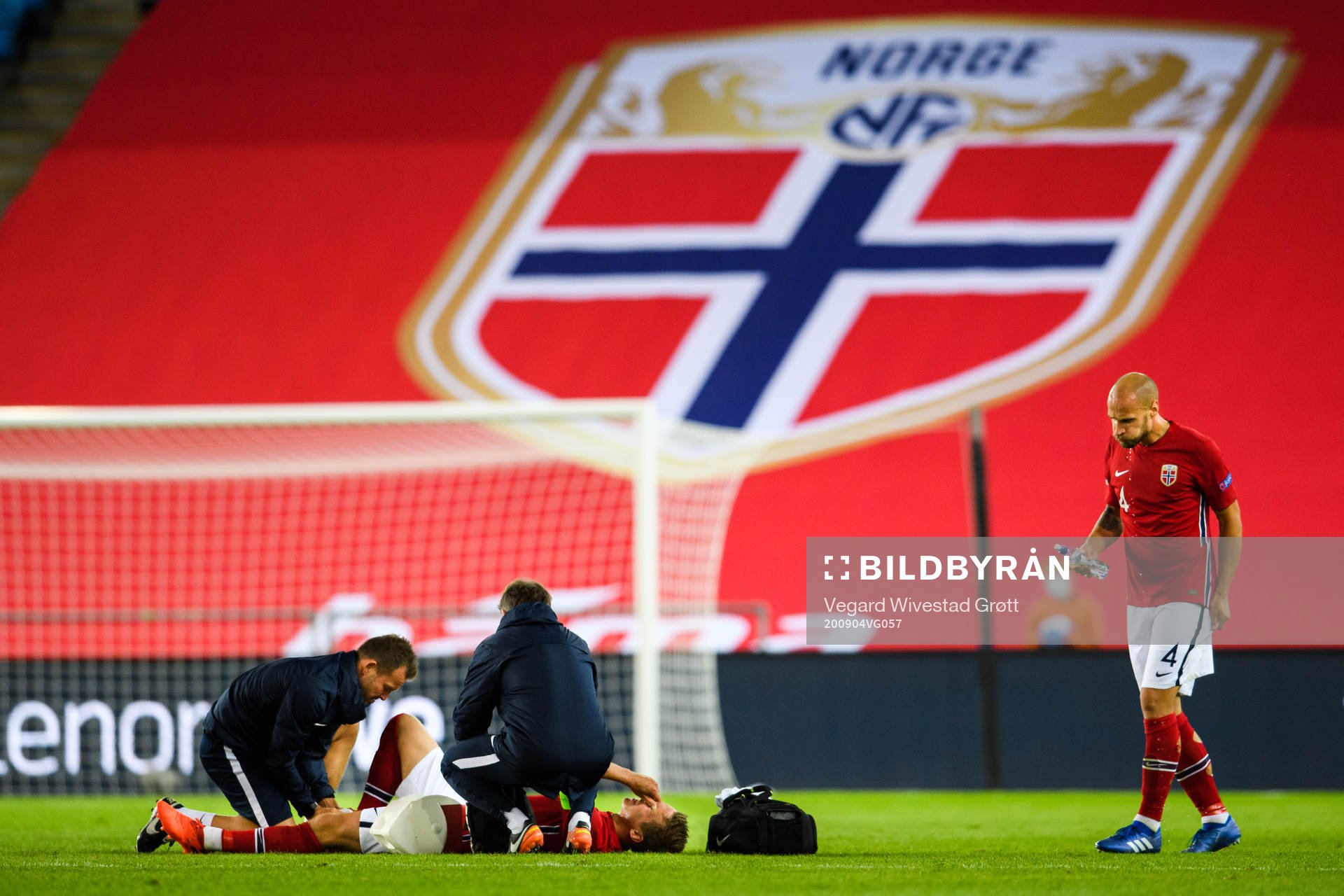 Stefan Johansen of Norway receives medical treatment