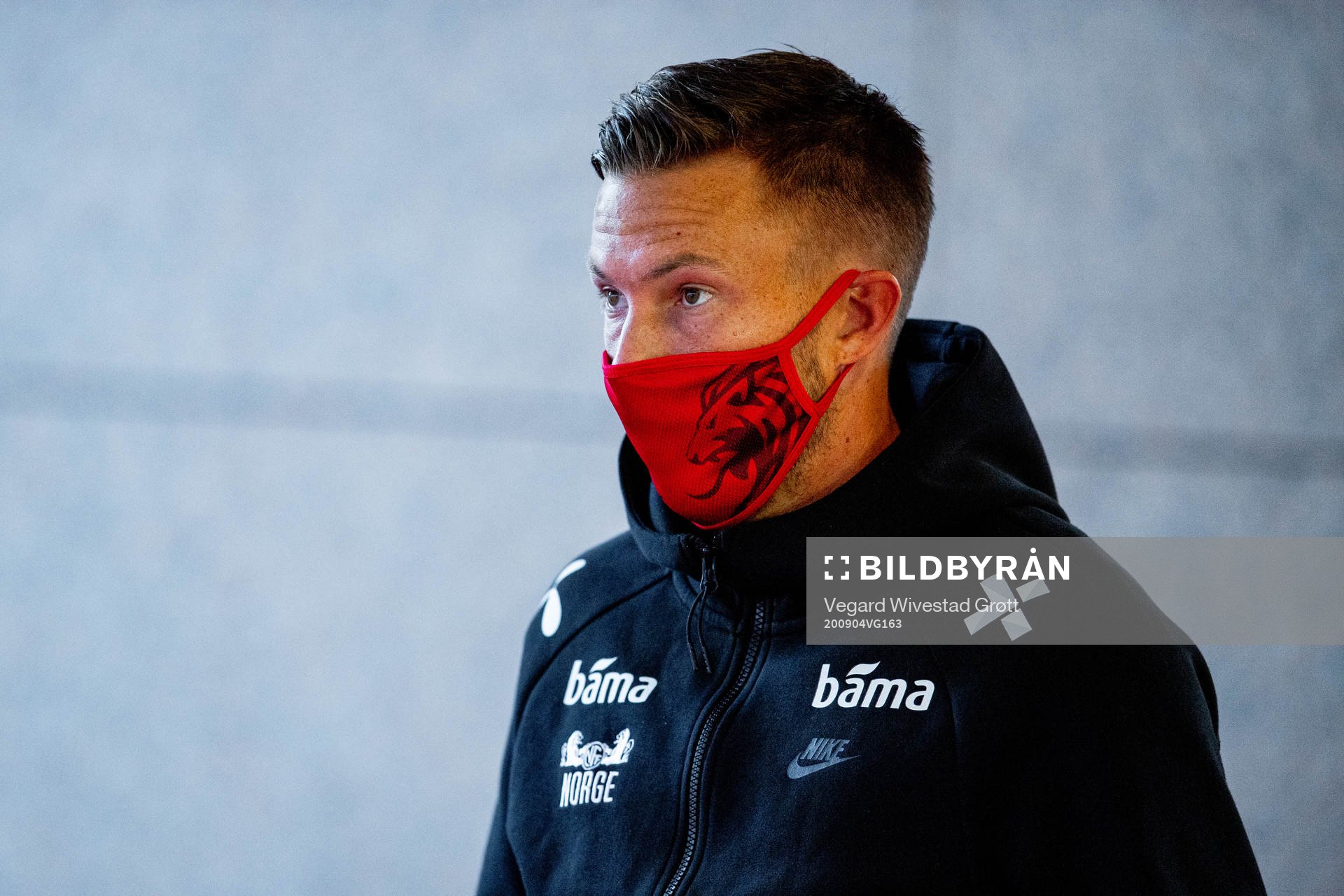 Martin Linnes of Norway arrives wearing a face mask